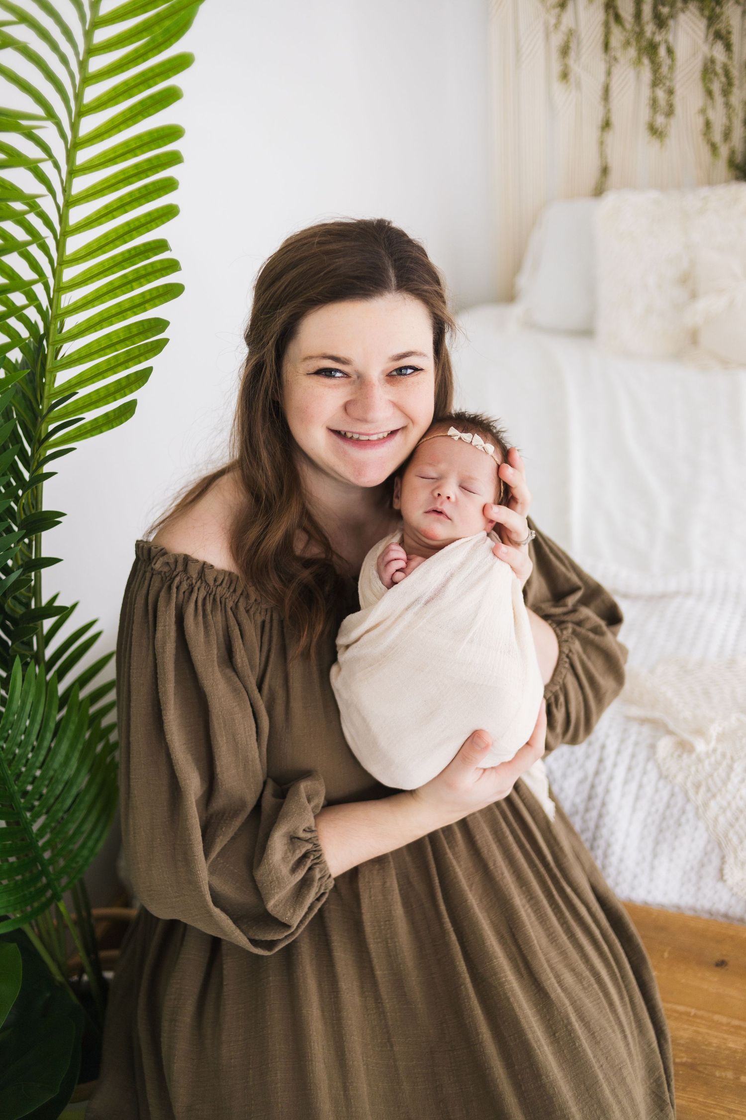 Tender family moment captured with indoor plants and natural lighting.