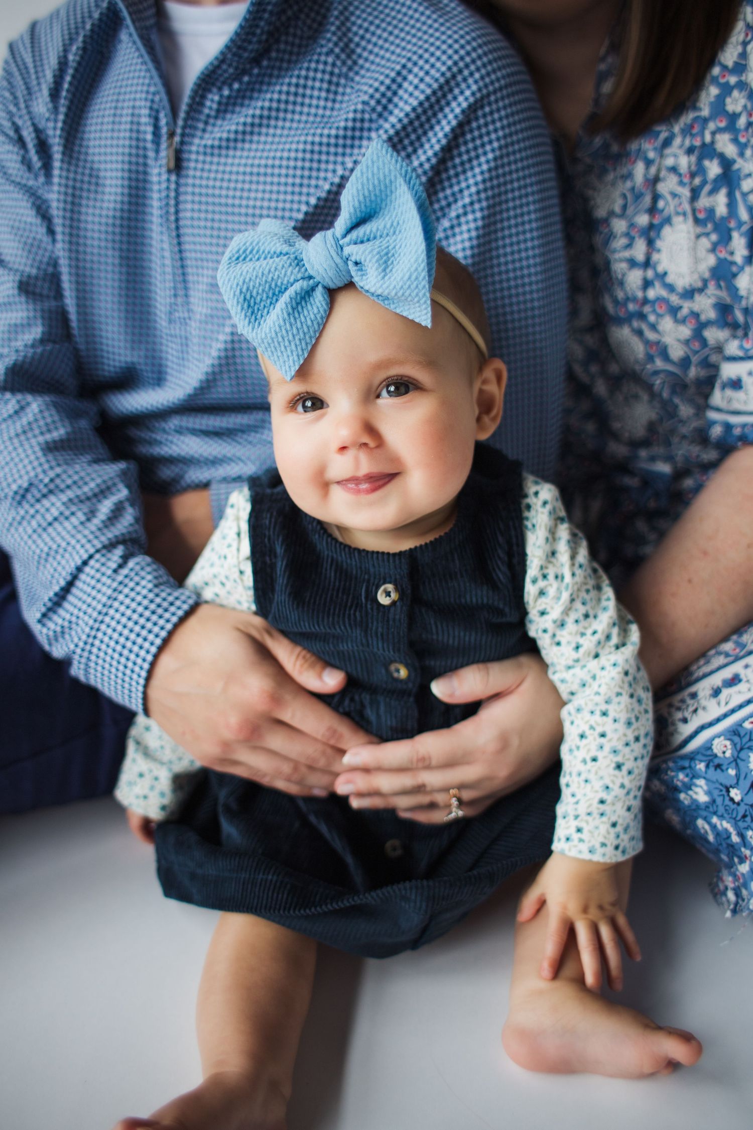 A series of cropped photos showing coordinating blue gingham and floral outfits with a matching bow accessory.