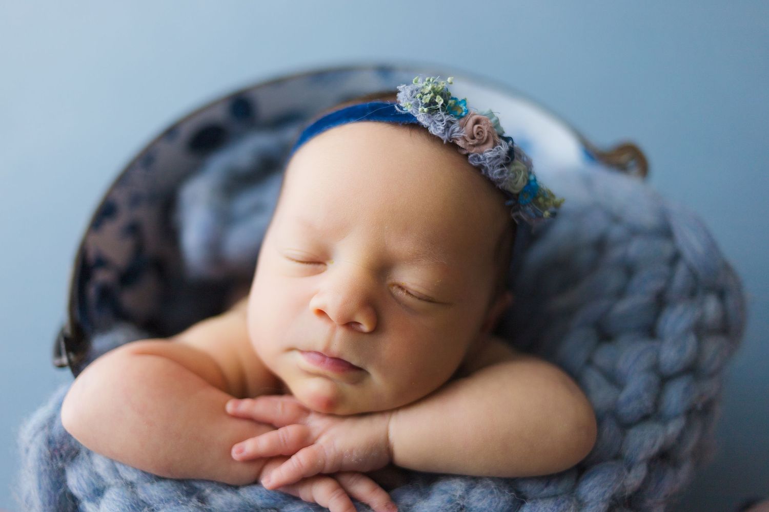 Newborn in wooden prop in studio, photographed by Fairchild Photo Co., Springfield newborn photographer, 417 area.