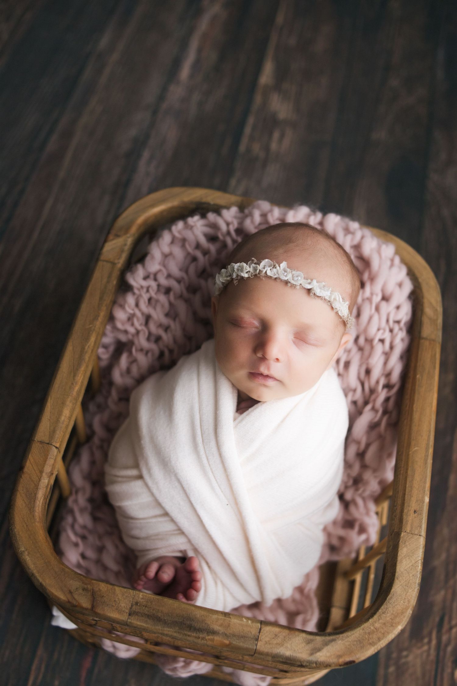 Springfield MO newborn photographer – posed newborn baby in studio wrapped in soft neutral blanket by Fairchild Photo Co