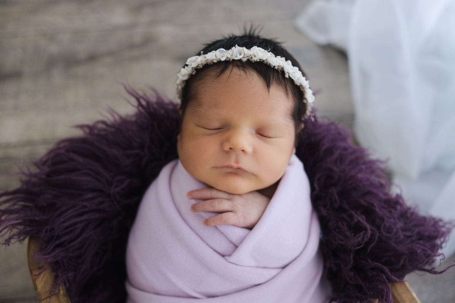 Springfield MO newborn photographer – baby wrapped in soft purple blanket during studio session by Fairchild Photo Co