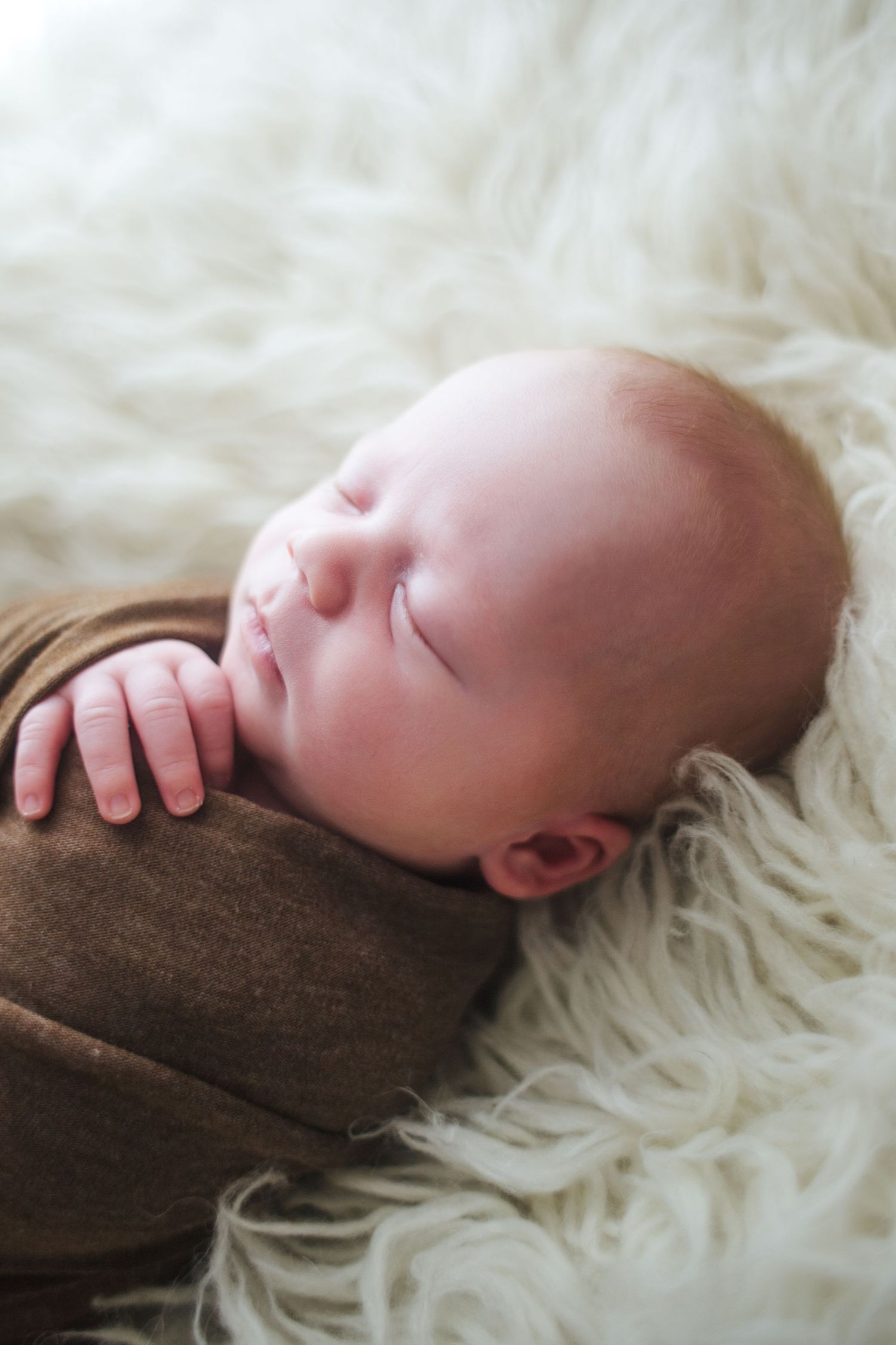 Award-winning Springfield MO newborn photographer with sleepy baby