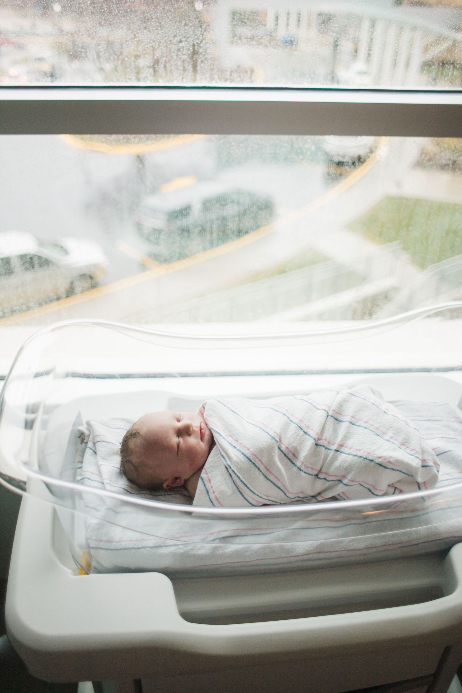 newborn baby swaddled in hospital bassinet during Fresh 48 session in Springfield MO