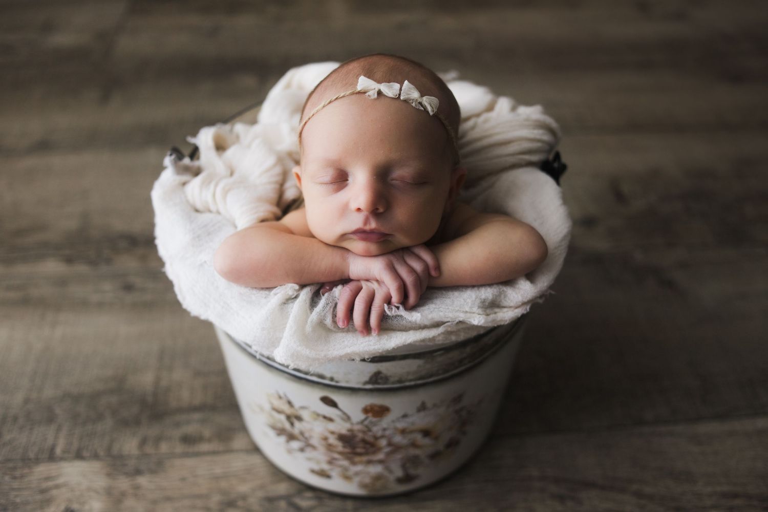 Cozy newborn wrapped snugly on cream blanket – Springfield Missouri baby photographer