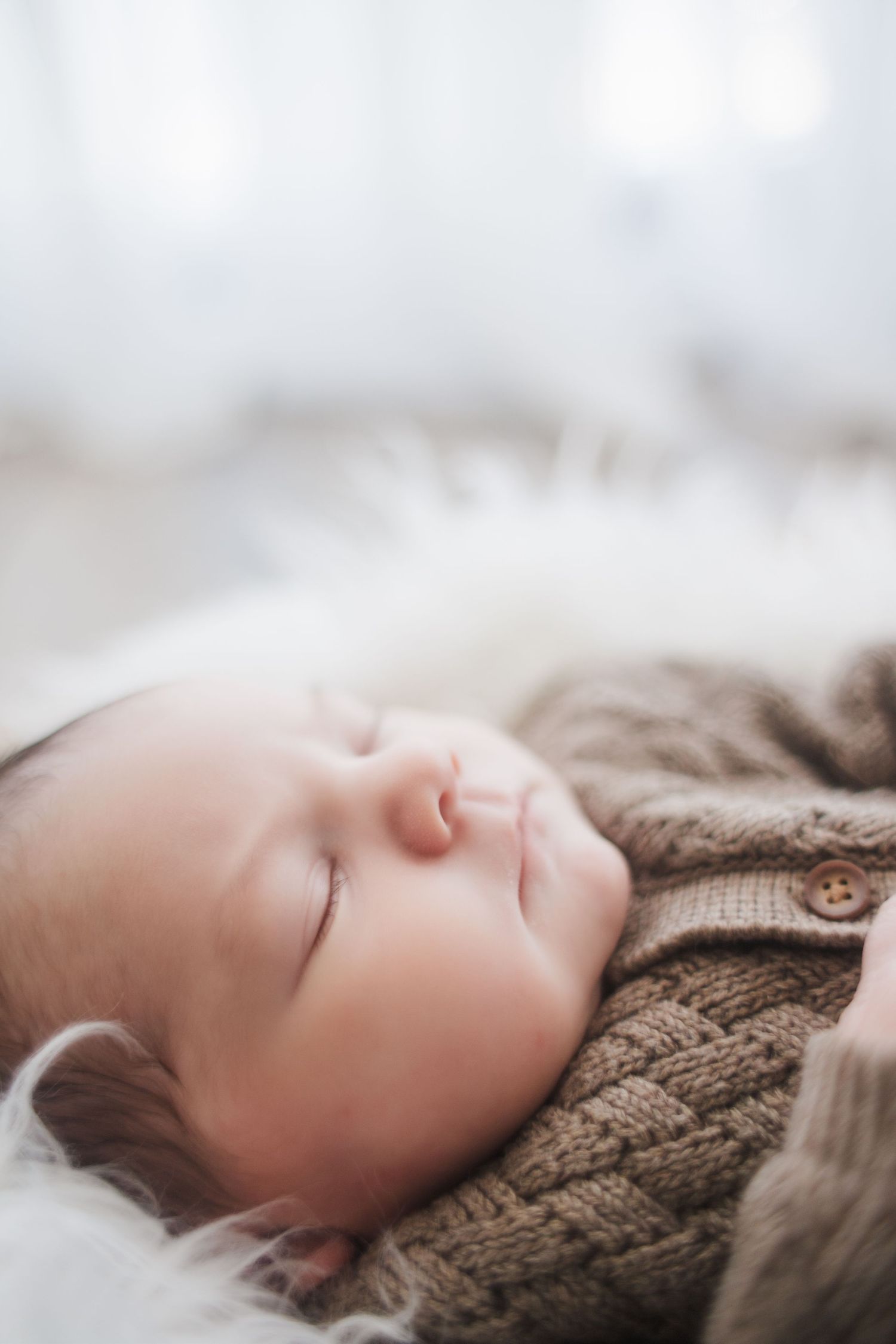 close up of sleeping newborn baby with soft dreamy natural light