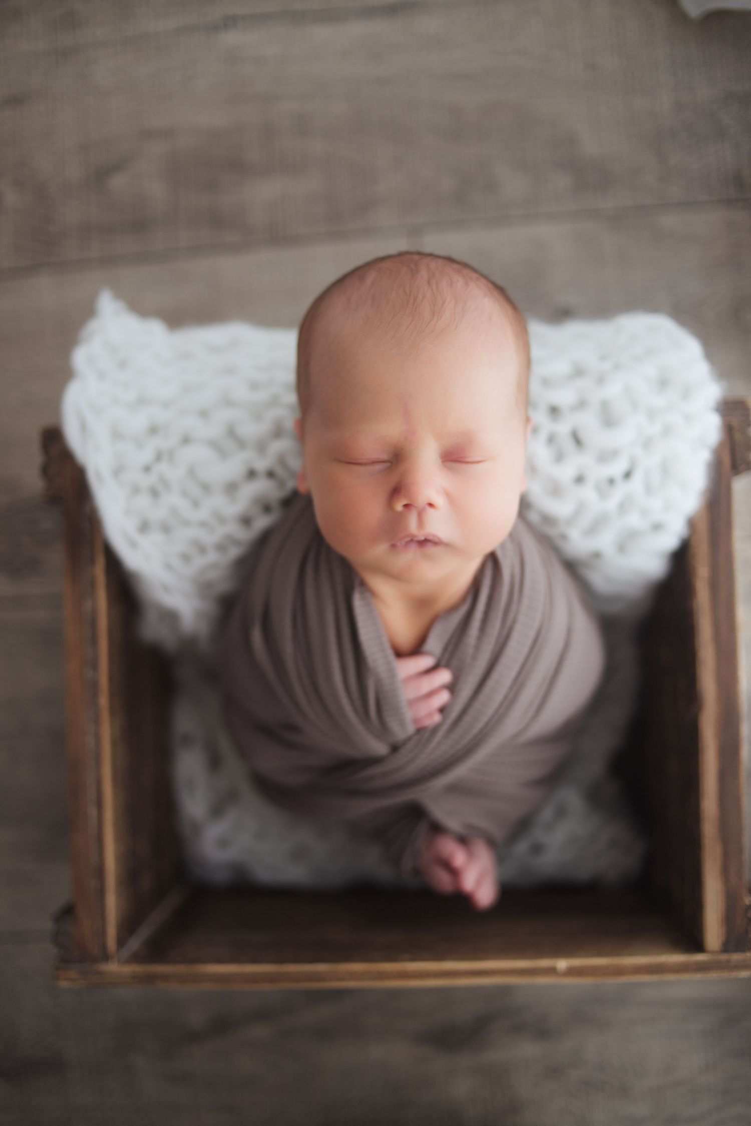 Newborn wrapped in warm neutral fabric – Fairchild Photo Co Springfield MO studio session