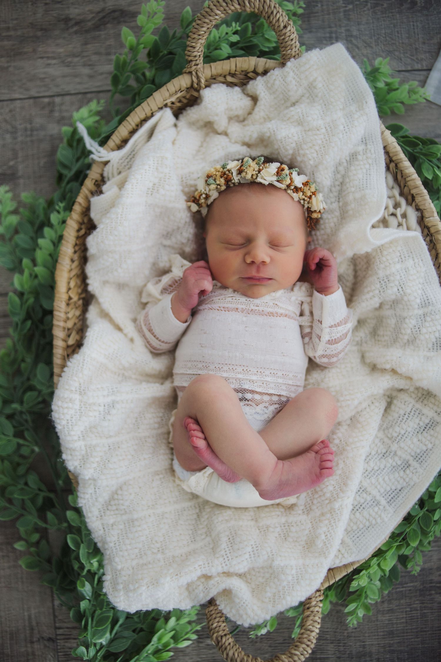 Baby wrapped in cream fabric on textured backdrop – timeless newborn photography Springfield MO