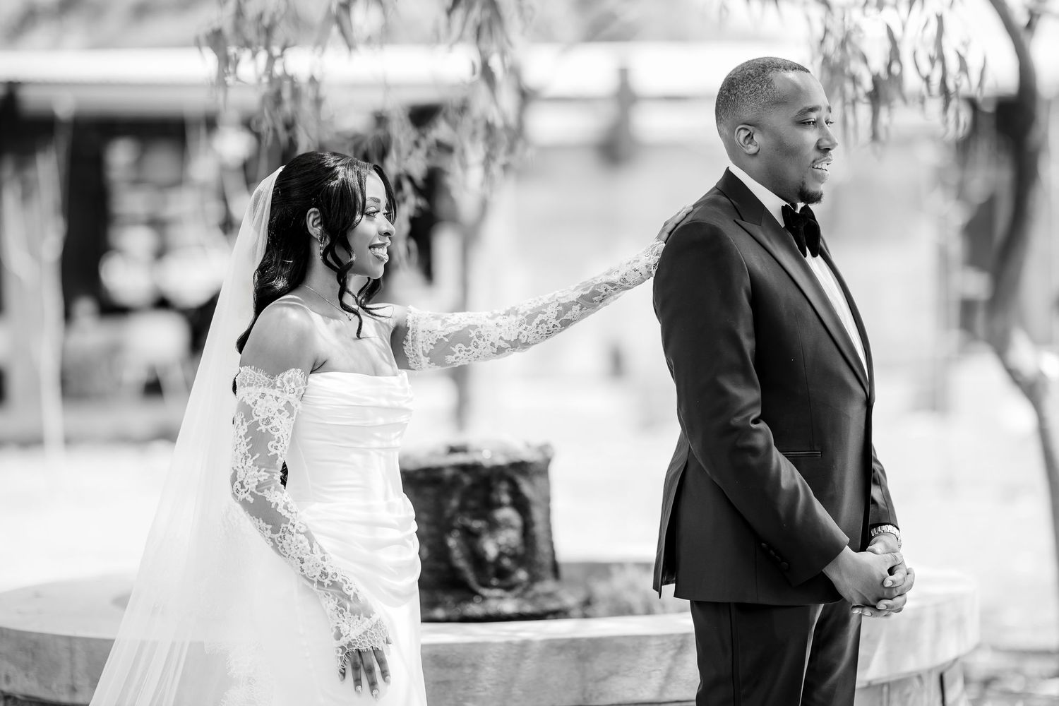 A couple shares a special moment during their first look at an outdoor wedding ceremony.