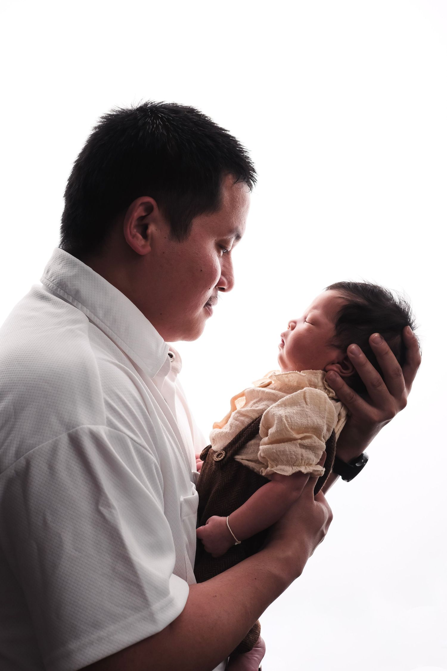 Side profile portrait of family members against white background.