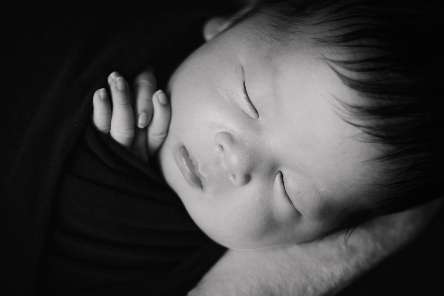 Artistic black and white close-up of sleeping baby.