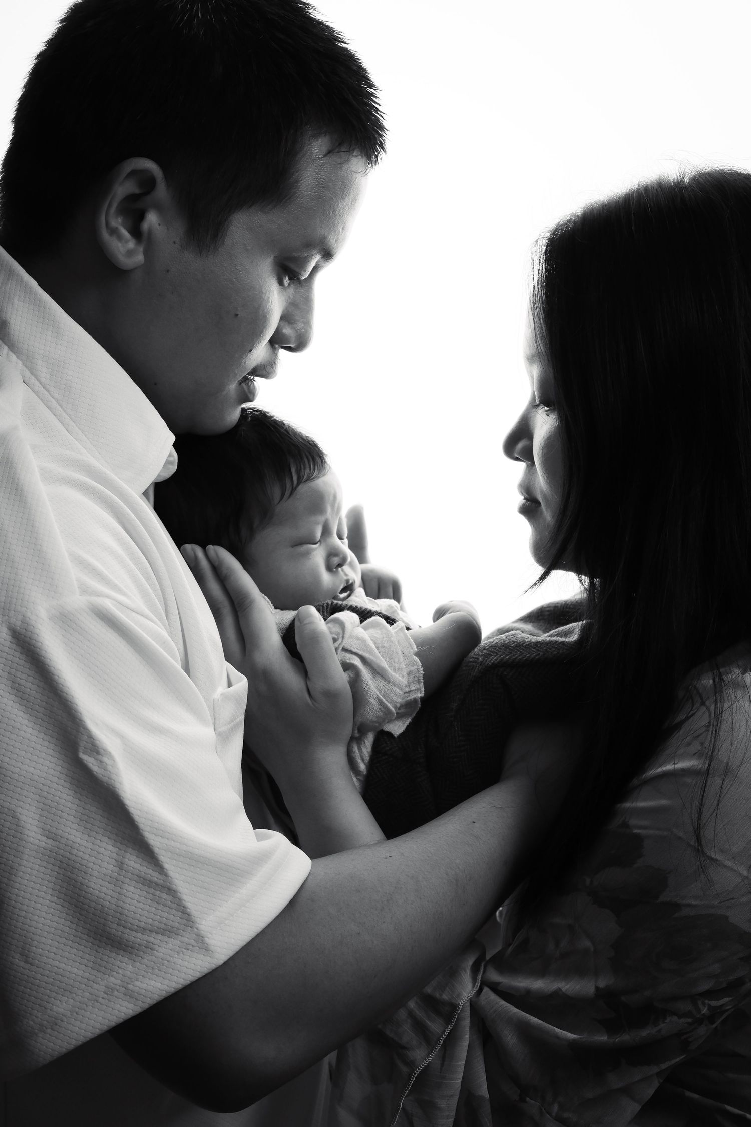 Artistic black and white family portrait showing tender moment.