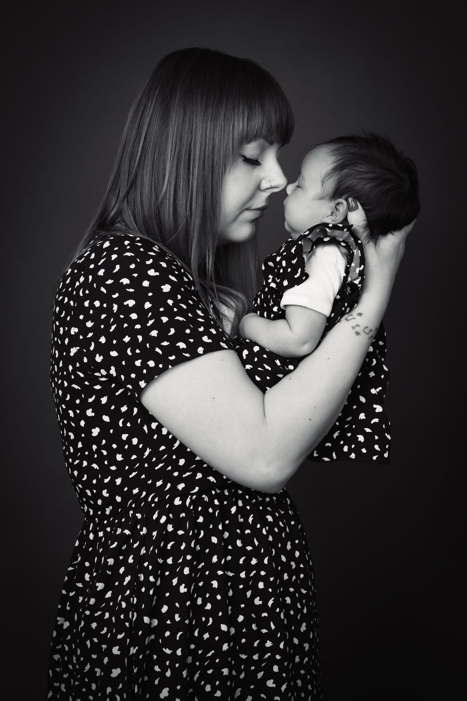 Artistic black and white series capturing gentle family bonding moments.