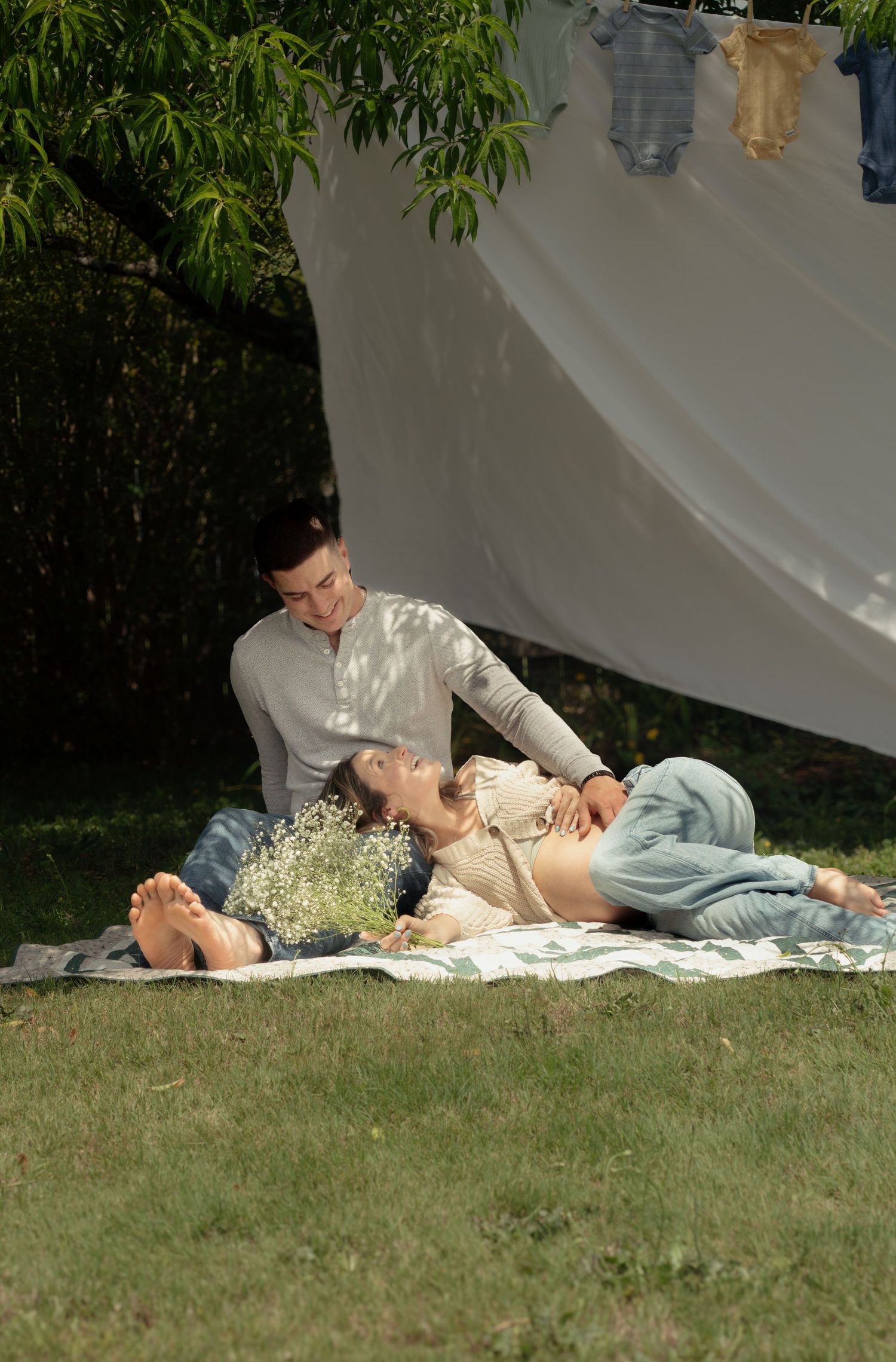 Expecting couple enjoying picnic during a candid maternity photography session in Fayetteville, NC.