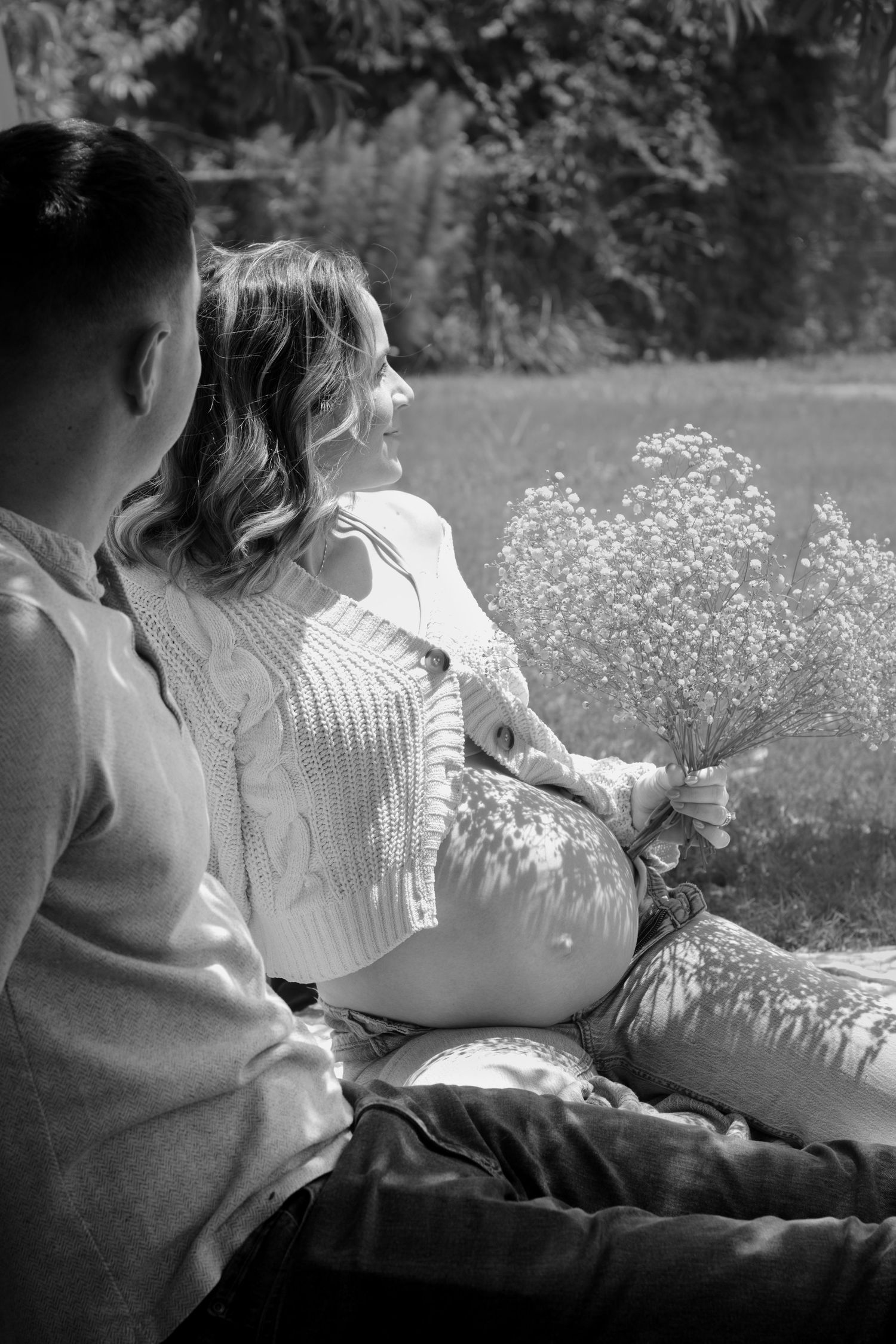 Expecting couple enjoying picnic during a candid maternity photography session in Fayetteville, NC.
