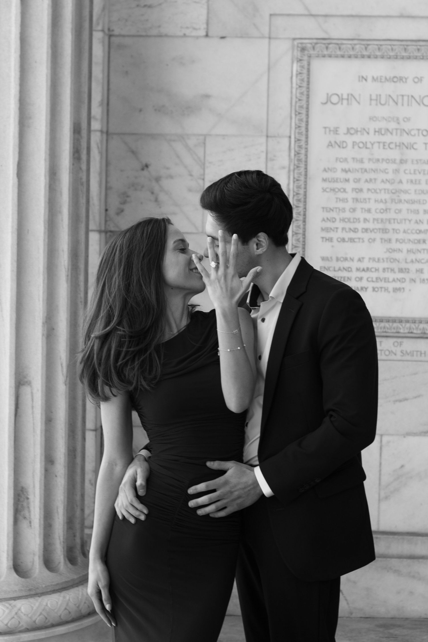 Engaged couple showing off ring outside the Cleveland Museum of Art in Cleveland, Ohio.