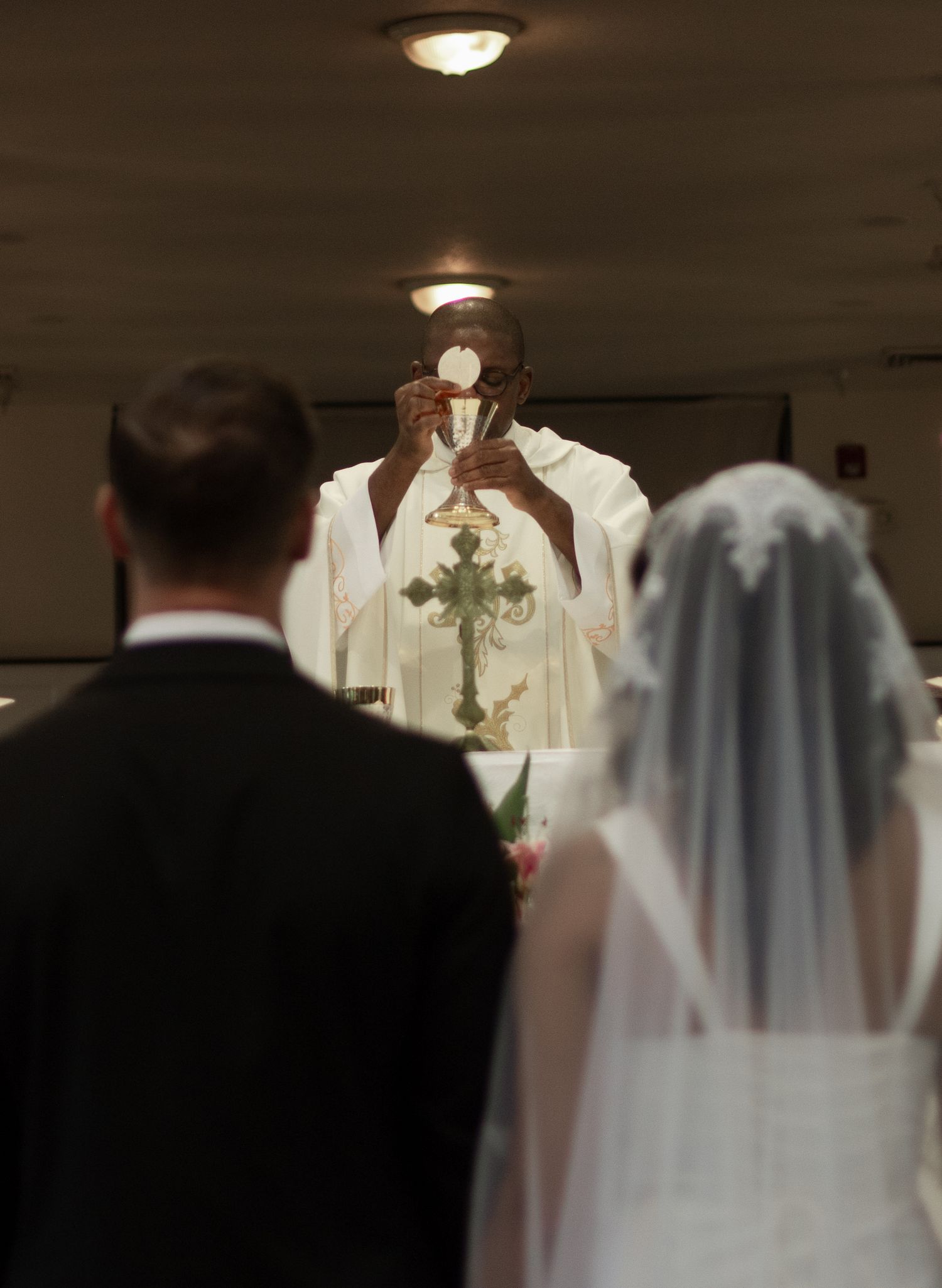 Bride and groom standing together at altar about to receive the communion during their intimate church wedding in Fayetteville, NC.