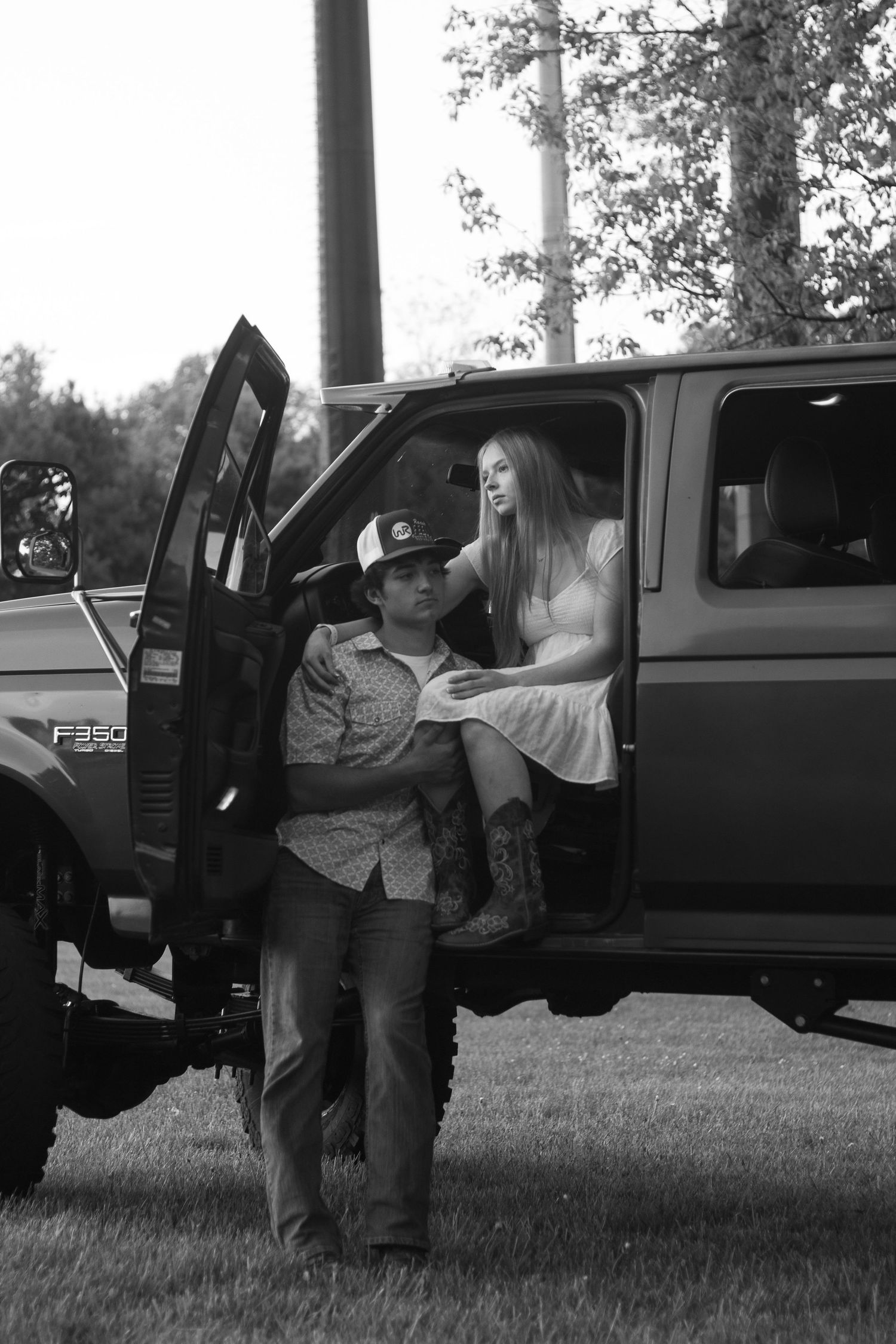Couple standing in truck door during a candid couples photography session in Orange, CT.