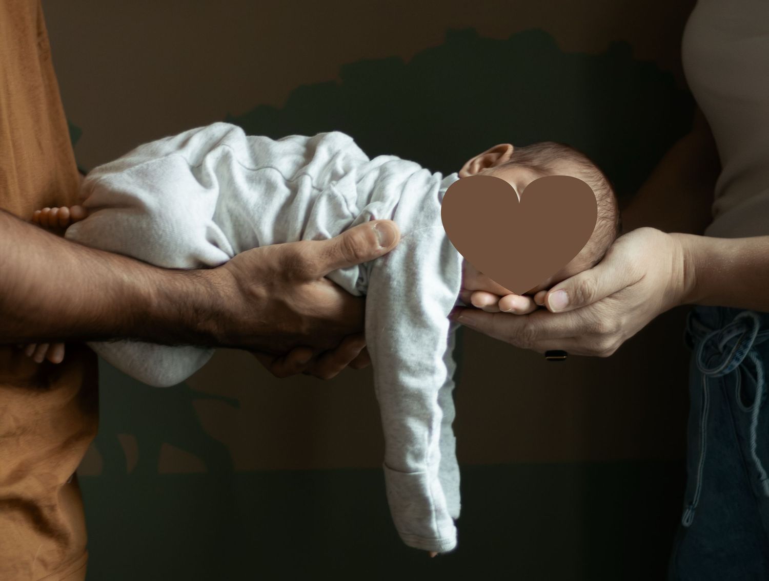 Parents gently holding their newborn baby during a Fayetteville, NC newborn photography session.