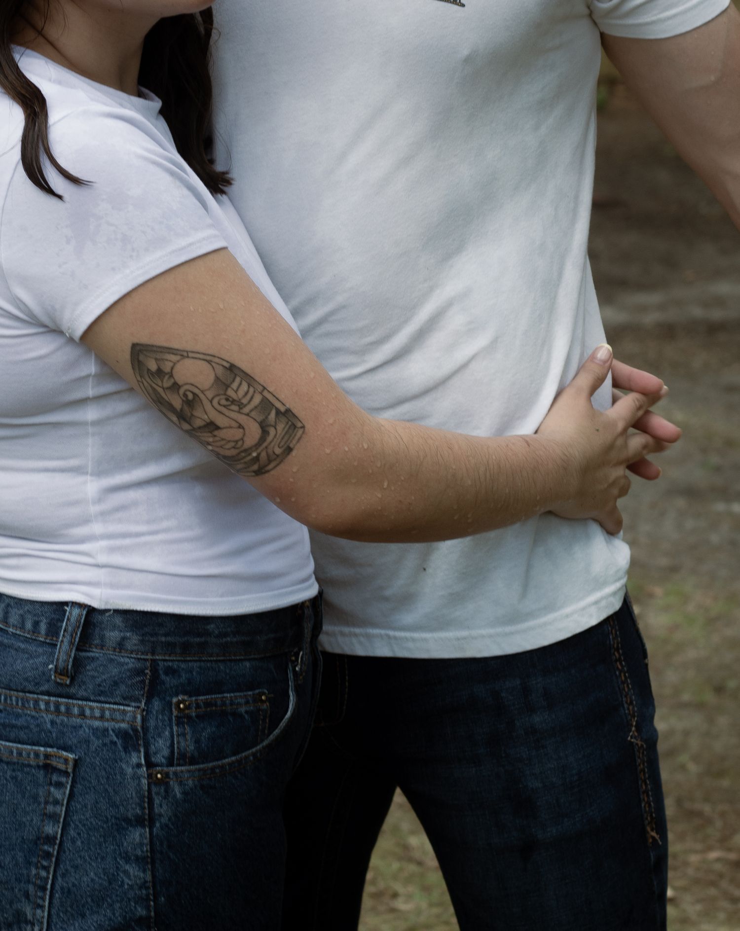 Detail shot of parents embracing during an outdoor family session in Raeford, NC.