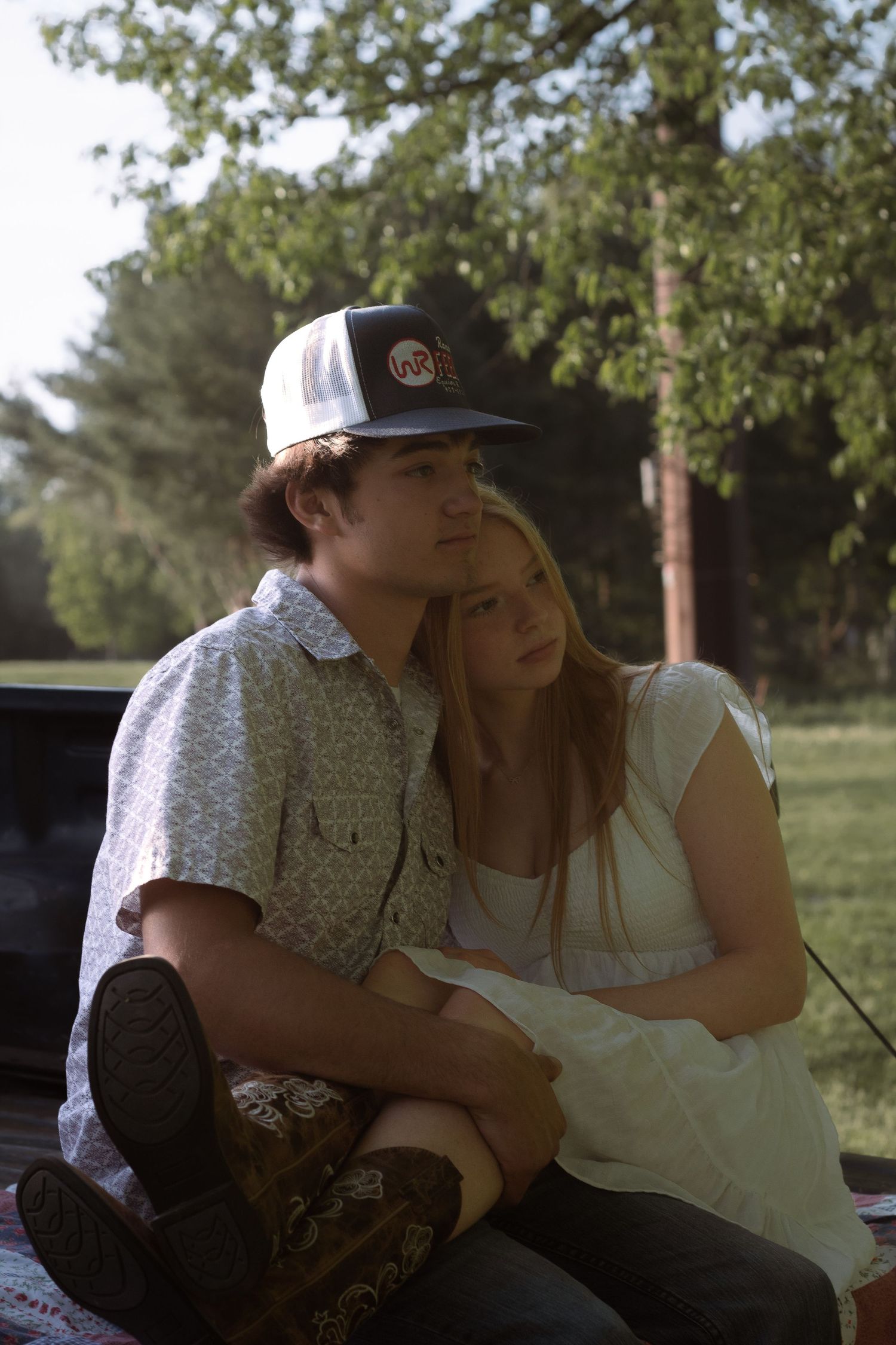 Couple sitting on truck bed during a candid couples photography session in Orange, CT.