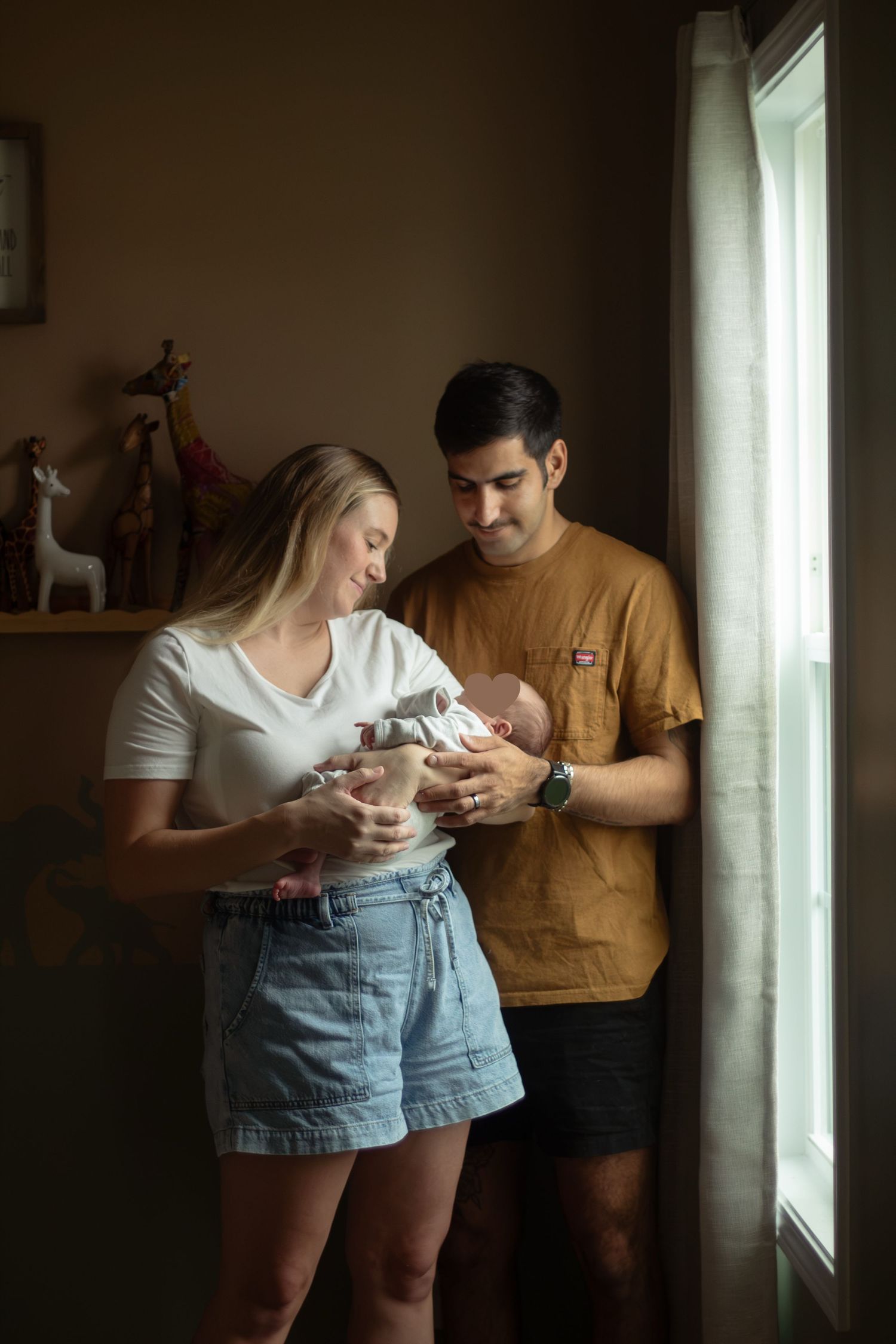 Parents holding their newborn baby during a Fayetteville, NC newborn photography session.