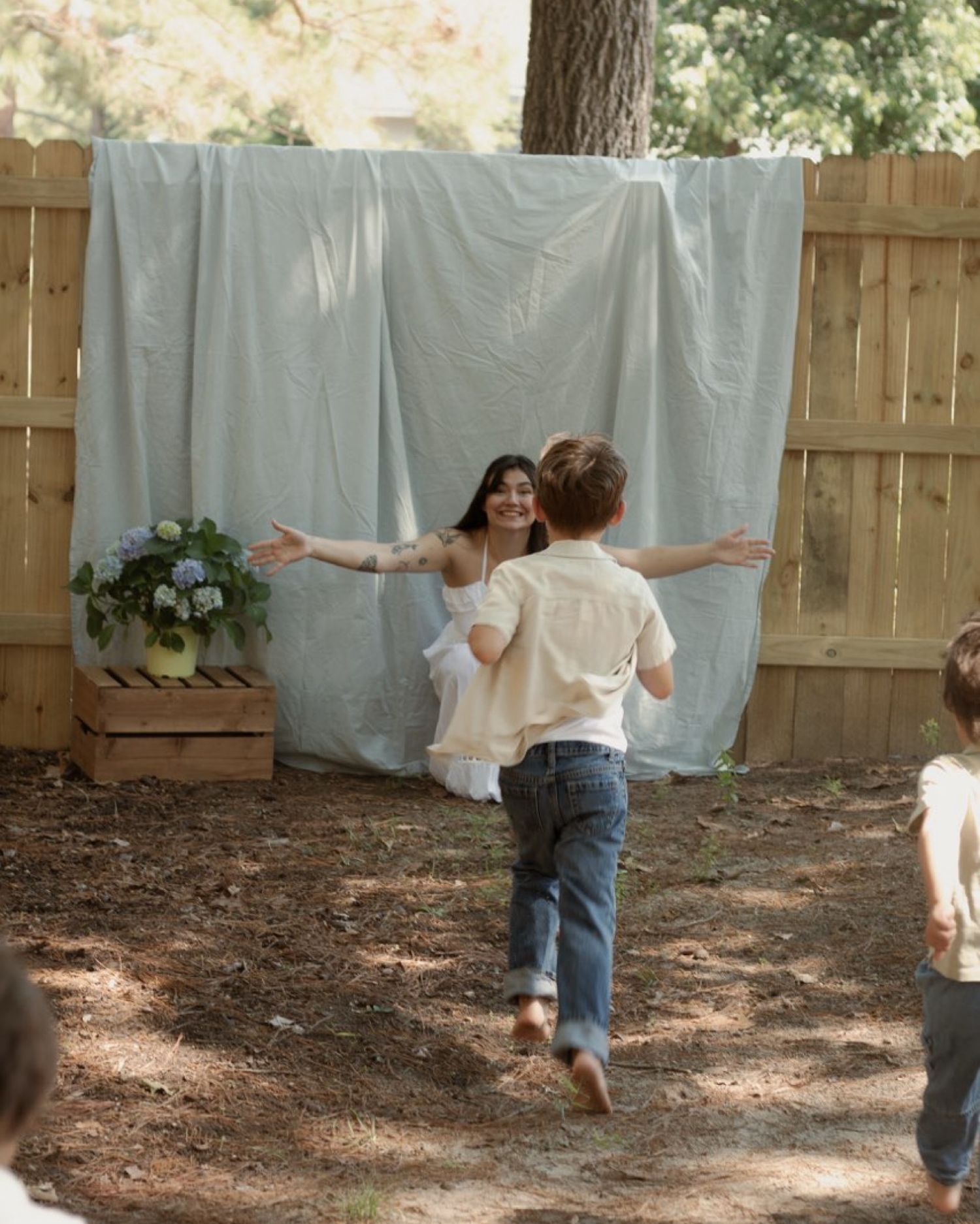 Kids running to mother during a playful mother's day photography session in Raeford, NC.