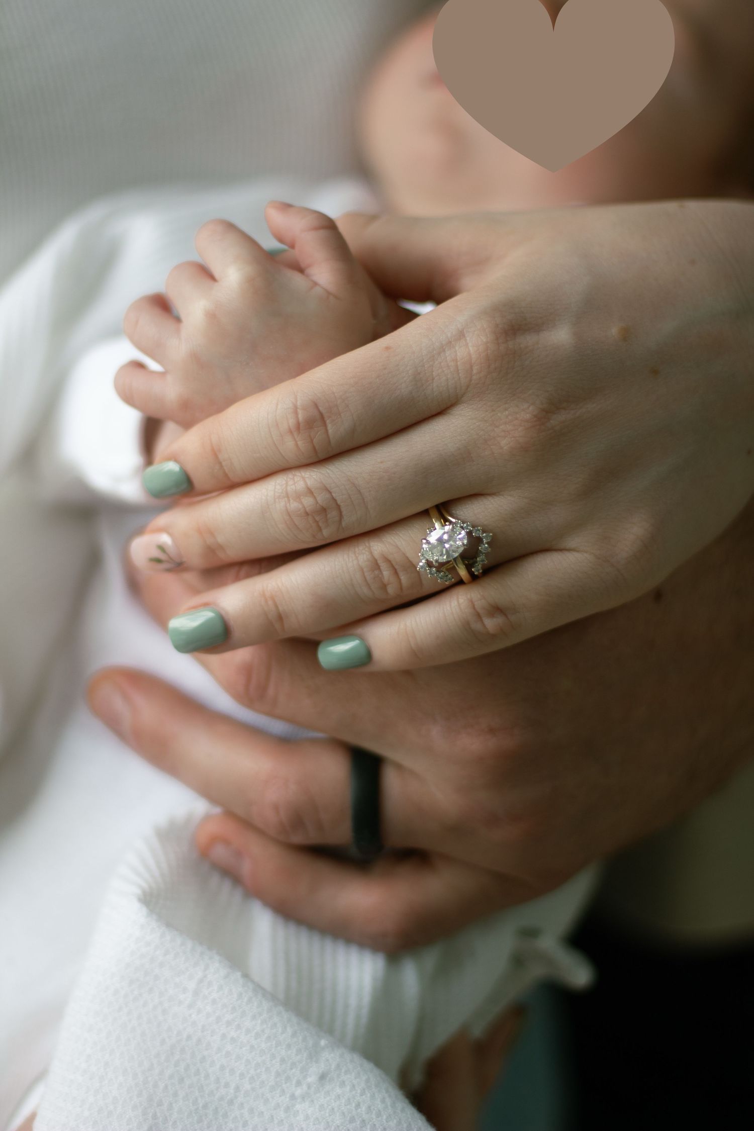 Close-up of a newborn baby's tiny hands with parents hands with wedding bands during a newborn photography session in Fayetteville, NC.