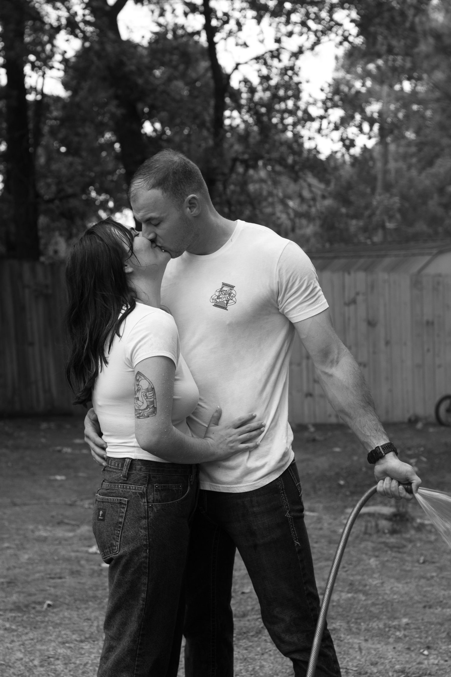 Parents sharing a sweet moment together during an outdoor family session in Raeford, NC.