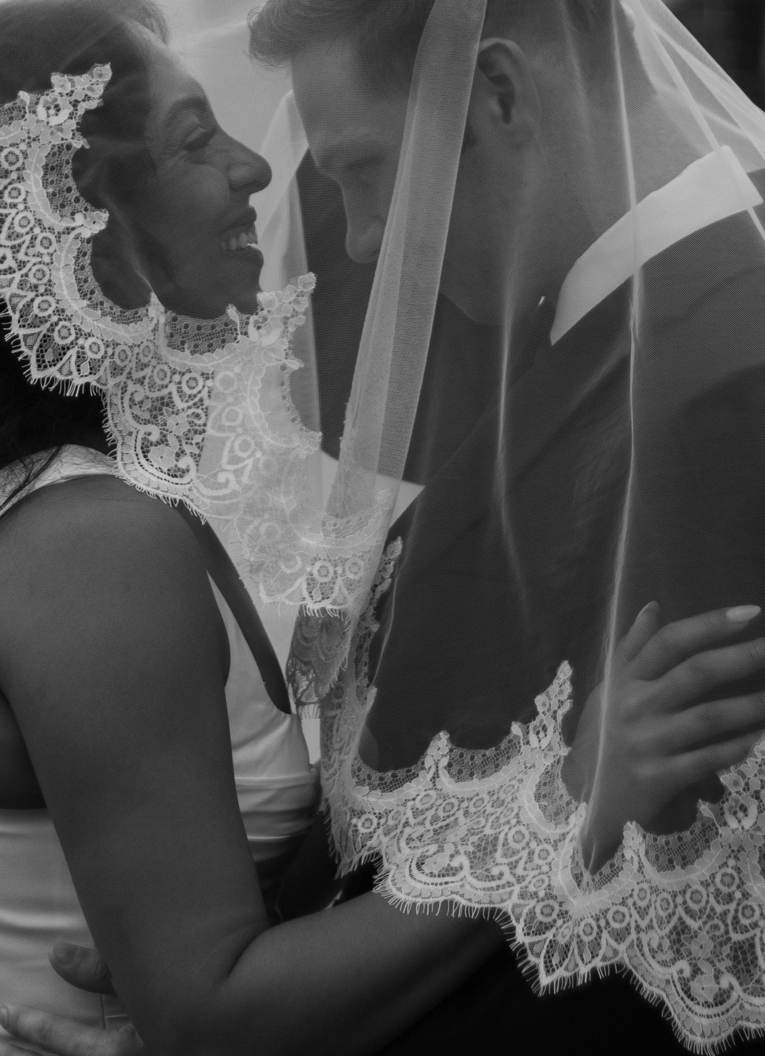 Bride and groom portraits under veil in front of church after their small church wedding in Fayetteville, NC.
