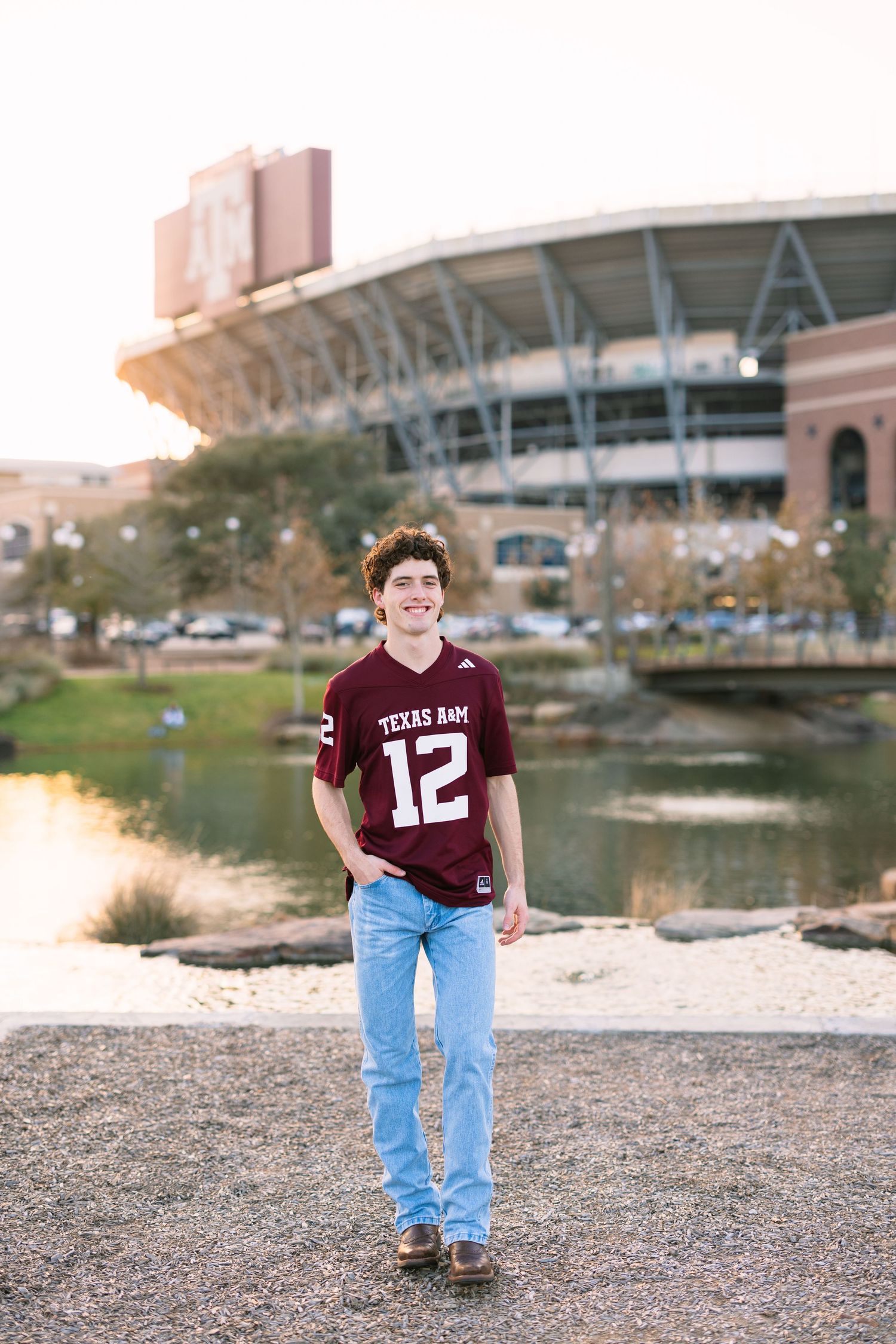 Four sequential photos show someone in a maroon sports jersey and jeans standing by a waterfront with stadium in background.
