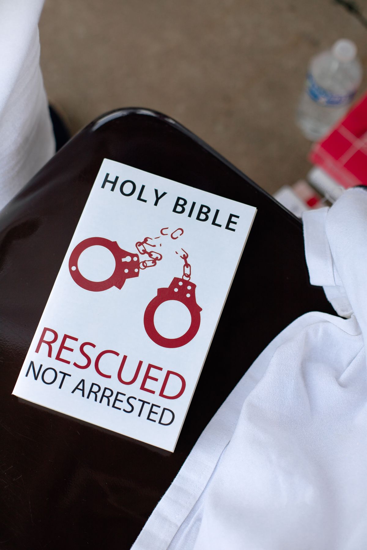 Series of cards showing Bible and arrest-themed text with handcuff graphics.