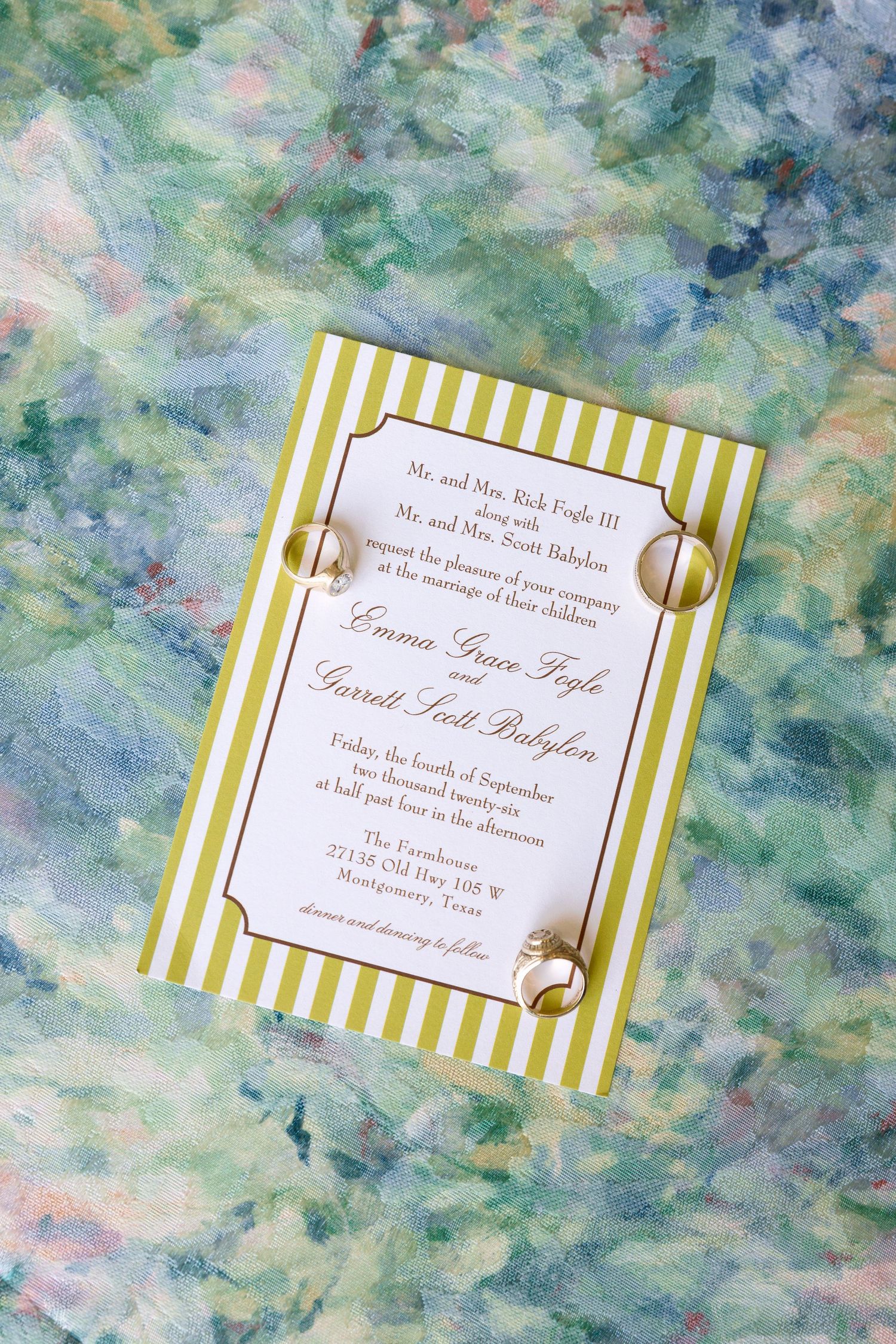 Green striped wedding invitation with gold rings for Emma Grace Foyle and Garrett Scott Babylon on a watercolor background.