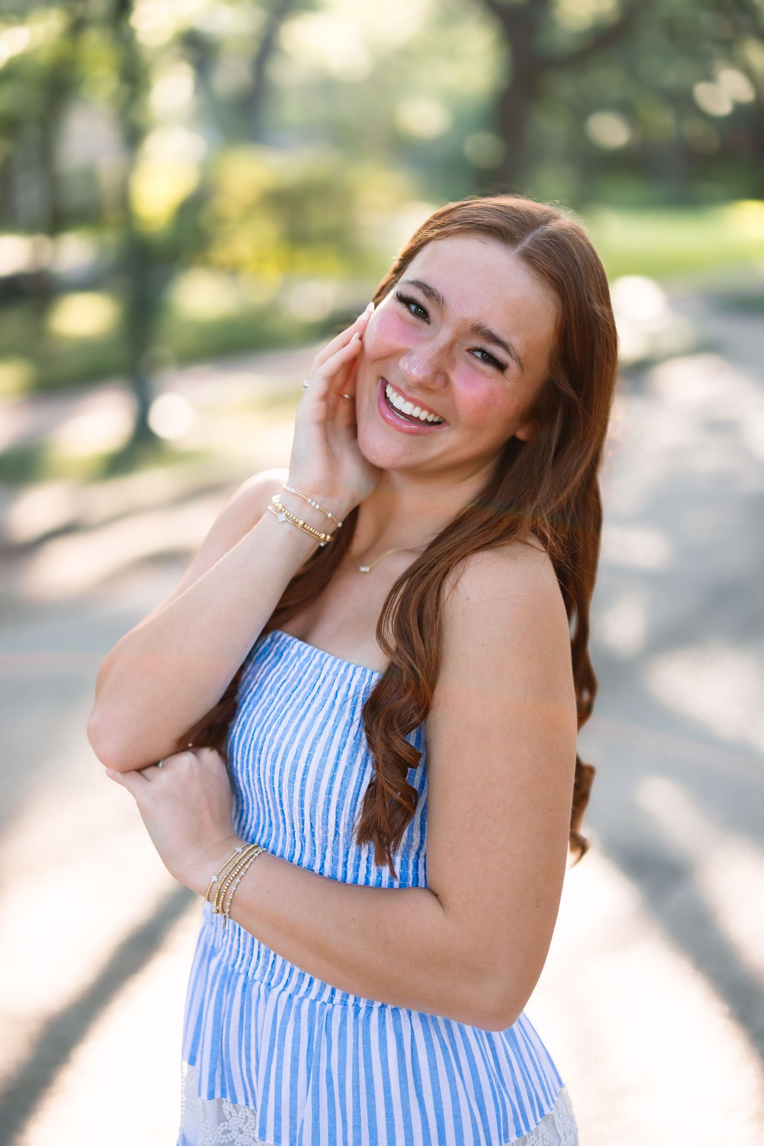 Summer portrait series in blue striped dress outdoors with natural lighting.