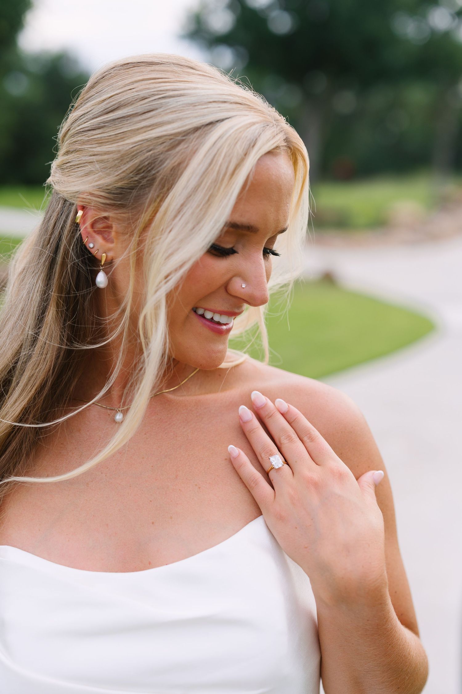 Close-up portrait in white top showing natural expressions and genuine smiles.