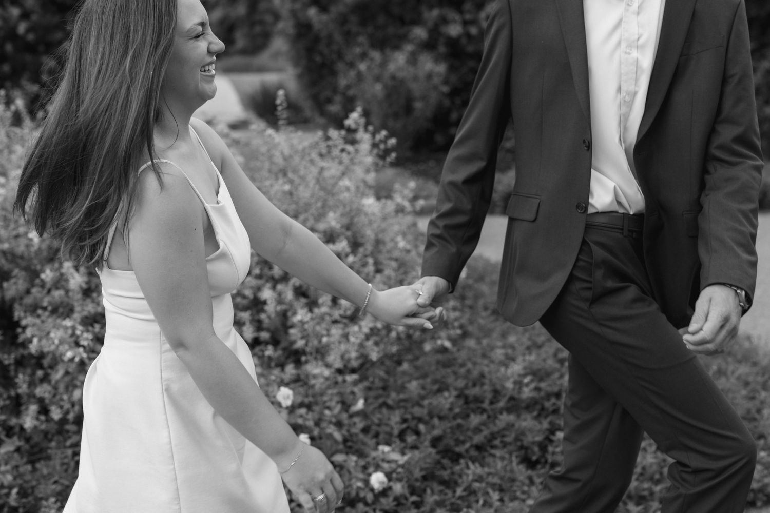 A romantic black and white portrait of a couple in formal attire sharing an intimate moment.