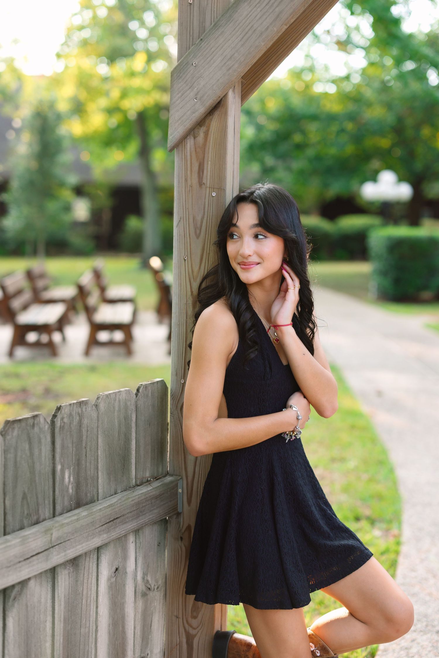 Casual outdoor portraits taken on a wooden bridge with natural lighting.