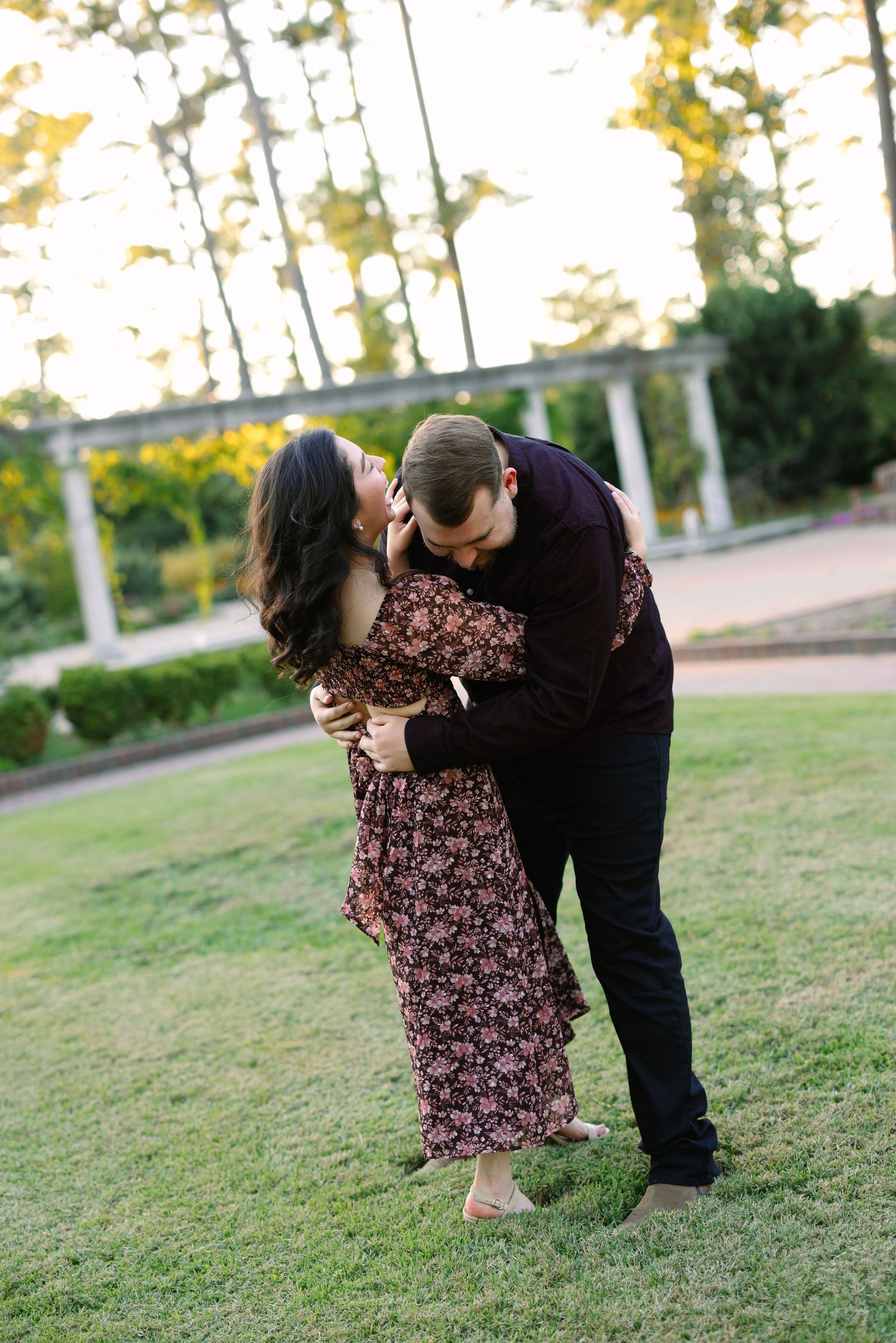 Romantic dip pose sequence in garden setting during golden hour photo shoot.