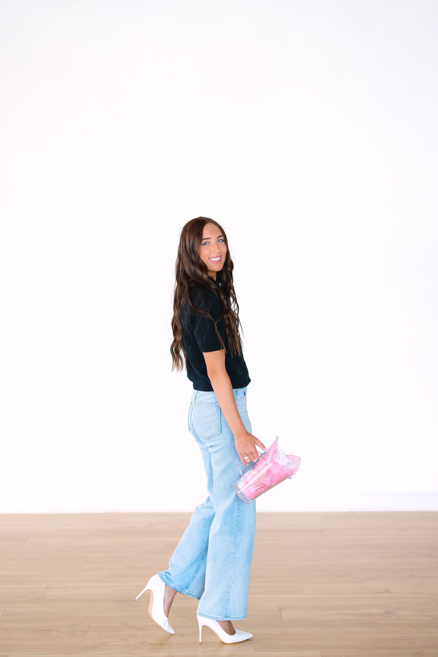 Dynamic shots of someone walking and posing in casual outfit with white shoes.