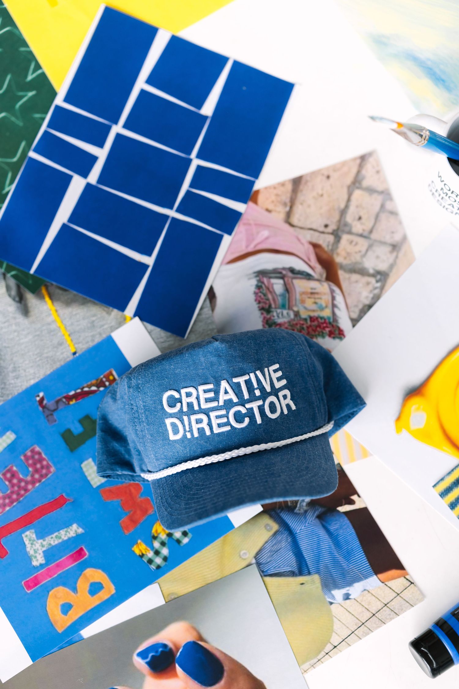 Creative director business card and colorful design materials laid out on a workspace.