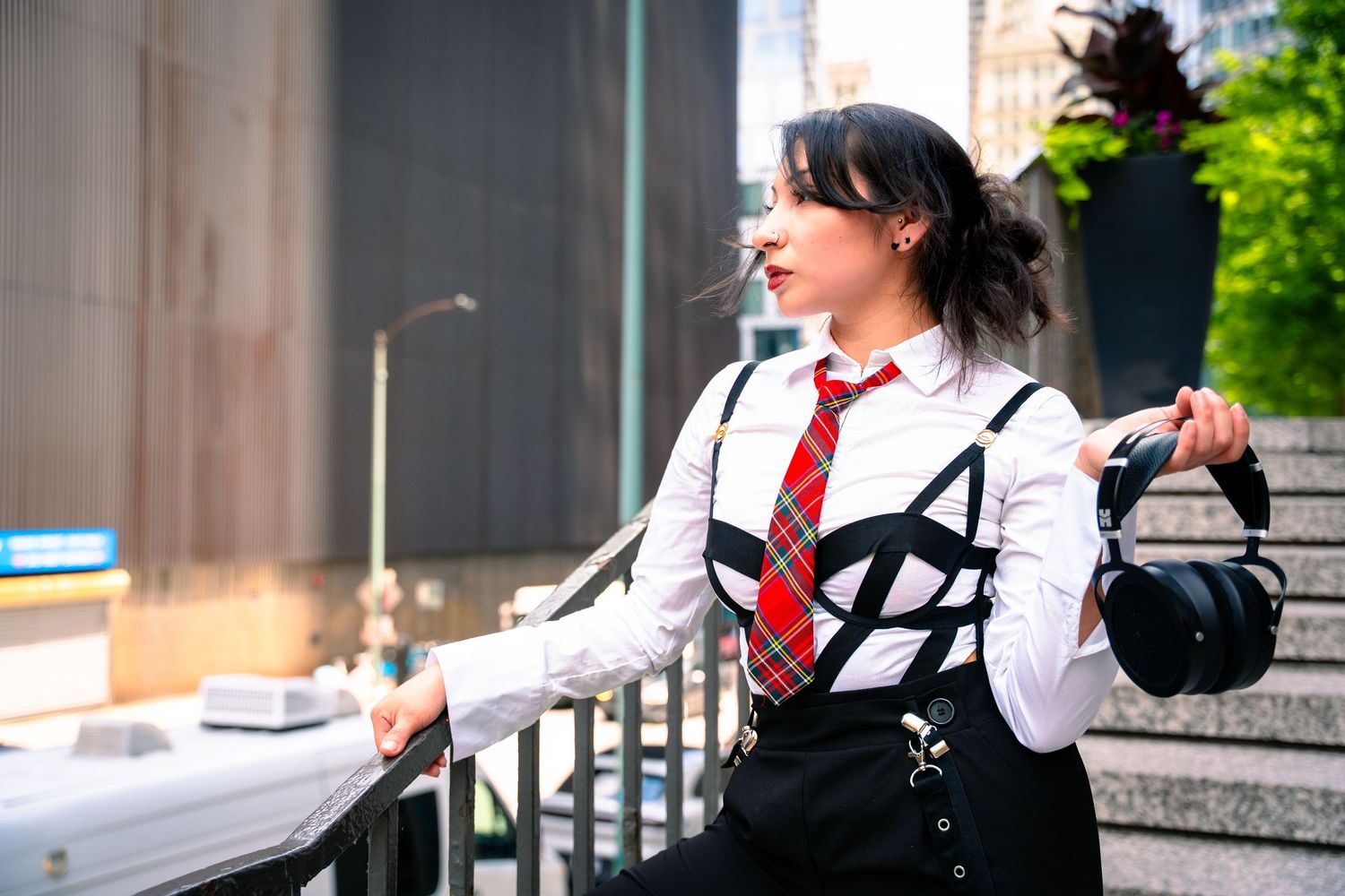 Fashion photography series on concrete steps with white shirt and red tie ensemble.
