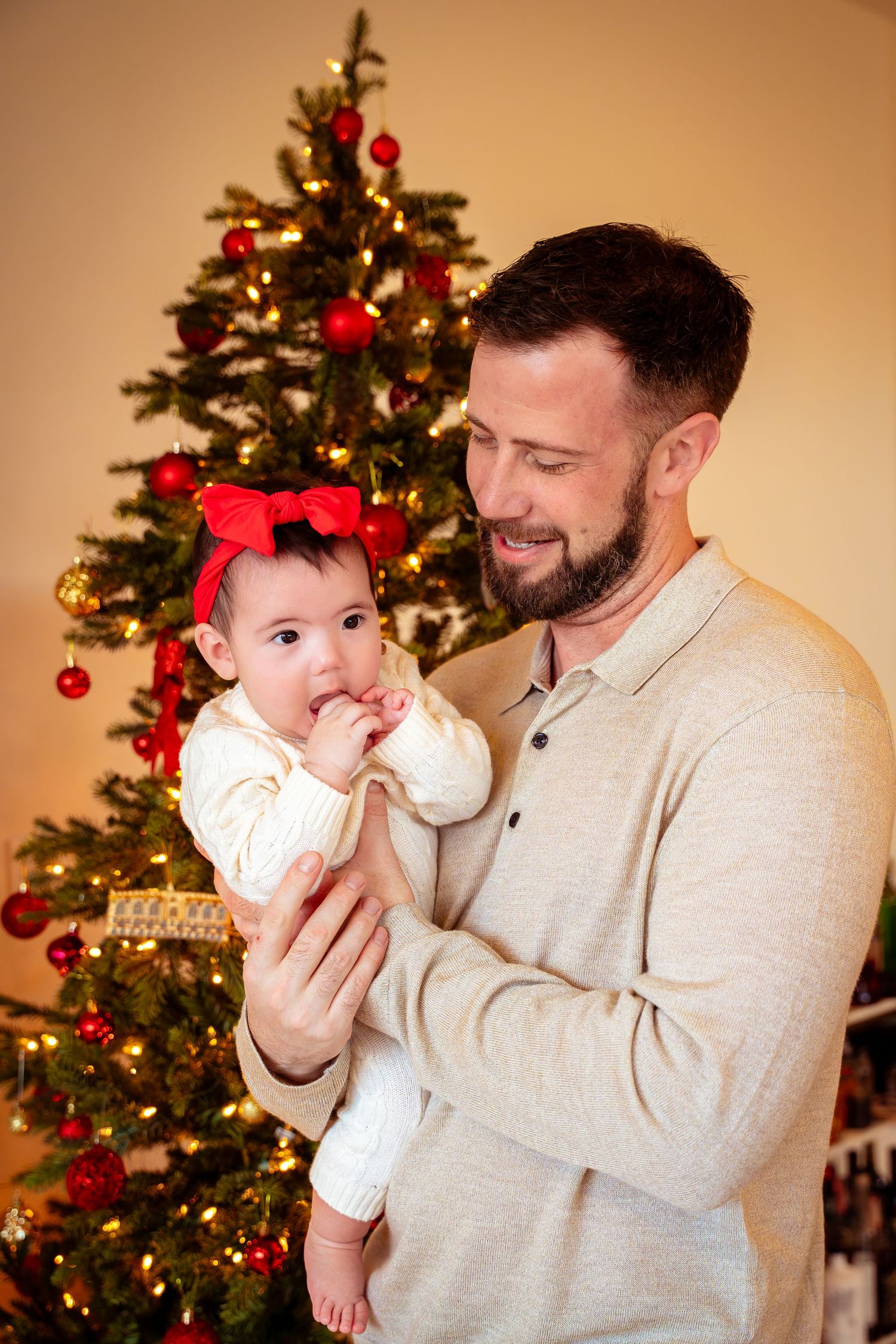Cozy Christmas scene with decorated tree and warm lighting creating festive holiday atmosphere.