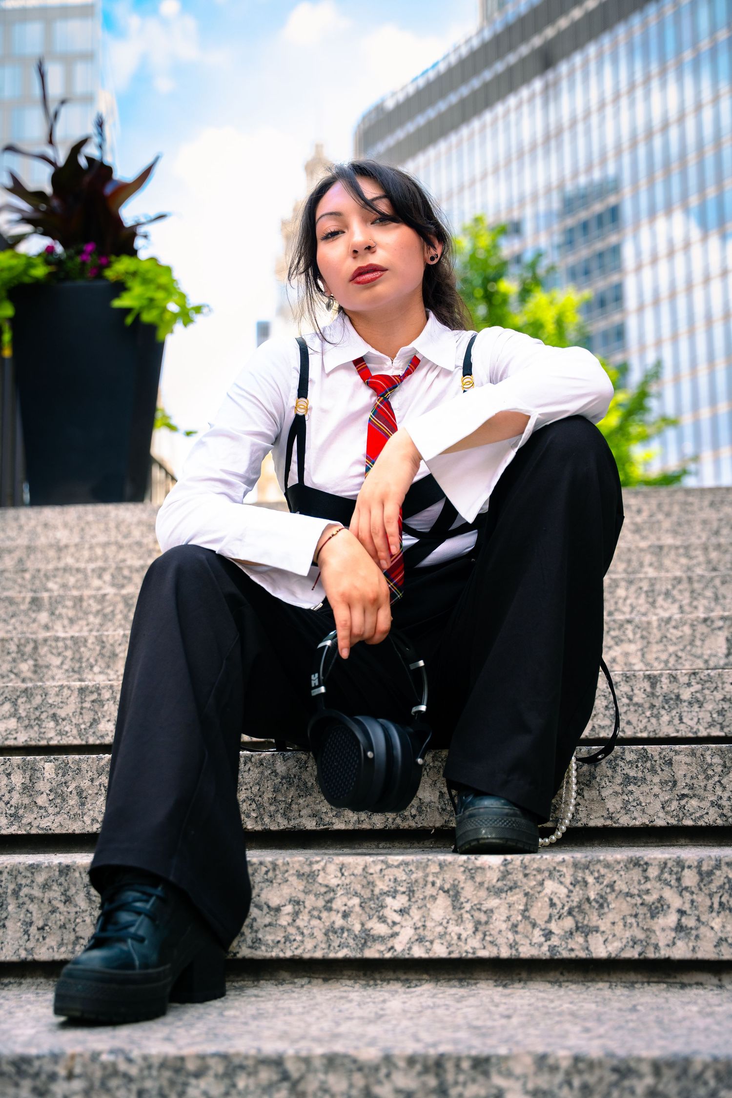 Fashion portraits on concrete steps featuring black and white formal wear with red accent tie.