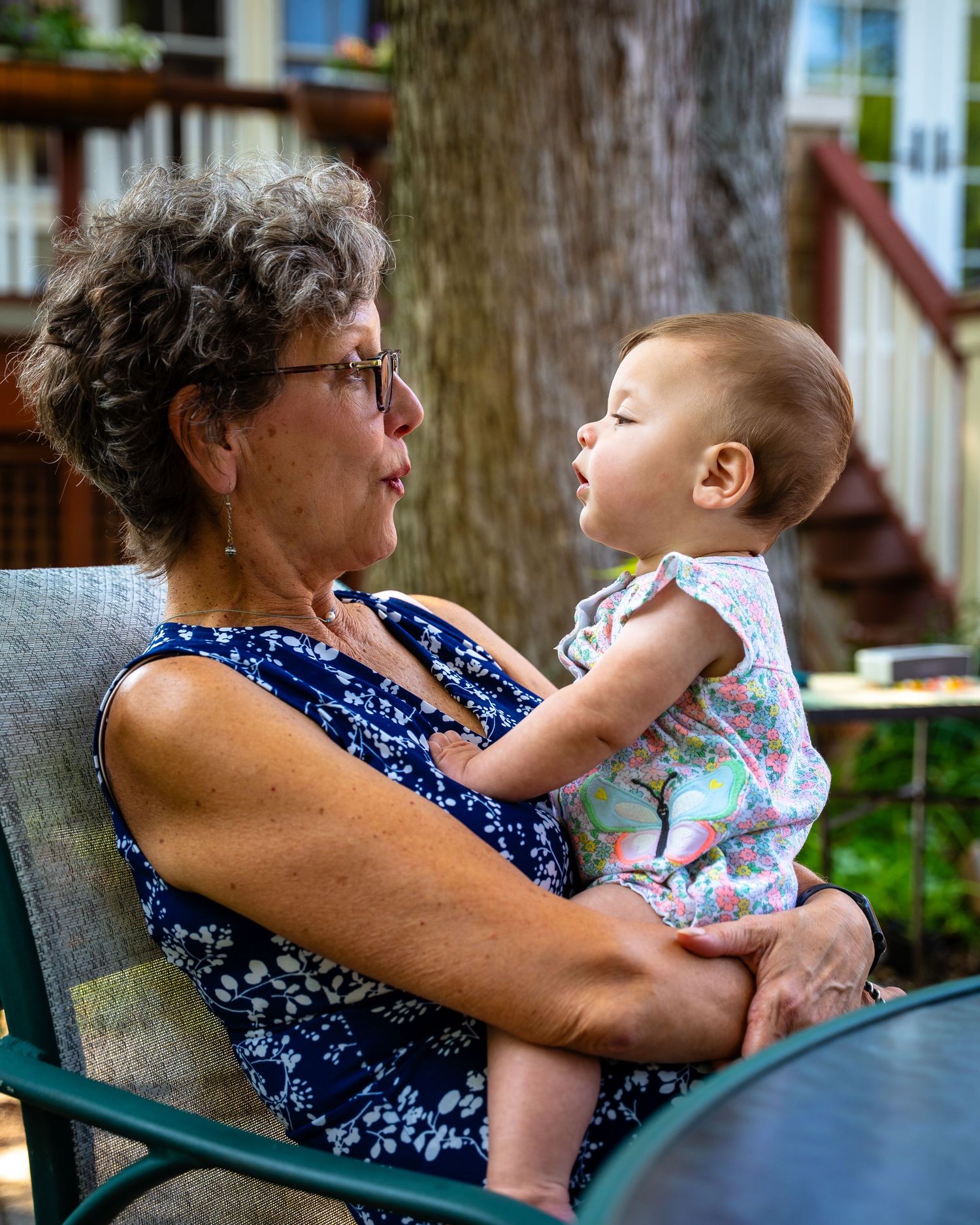 Series of intimate family moments captured on a wooden bench showing tender interactions in a garden setting.