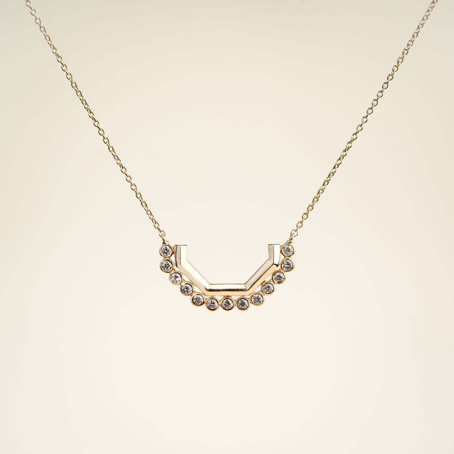 Minimalist rose gold bar necklace with delicate crystal accents on white background.