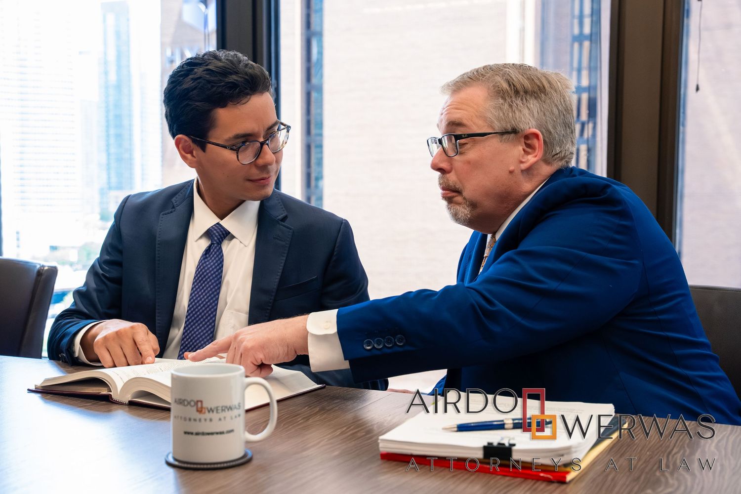 Legal team collaborating during business meeting at conference table.