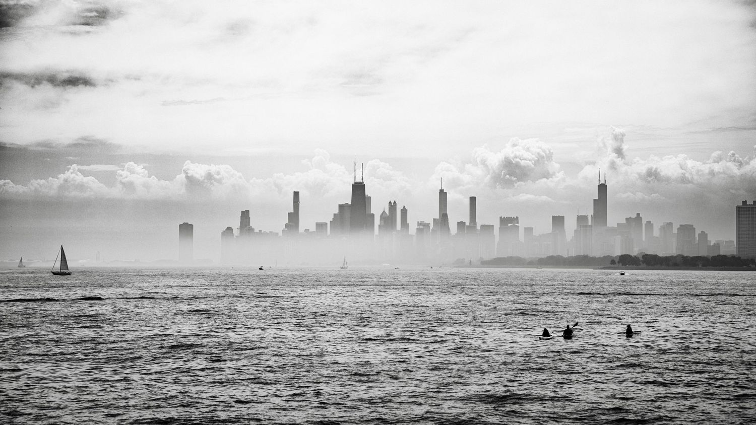 Black and white panoramic skyline of Chicago viewed across Lake Michigan.