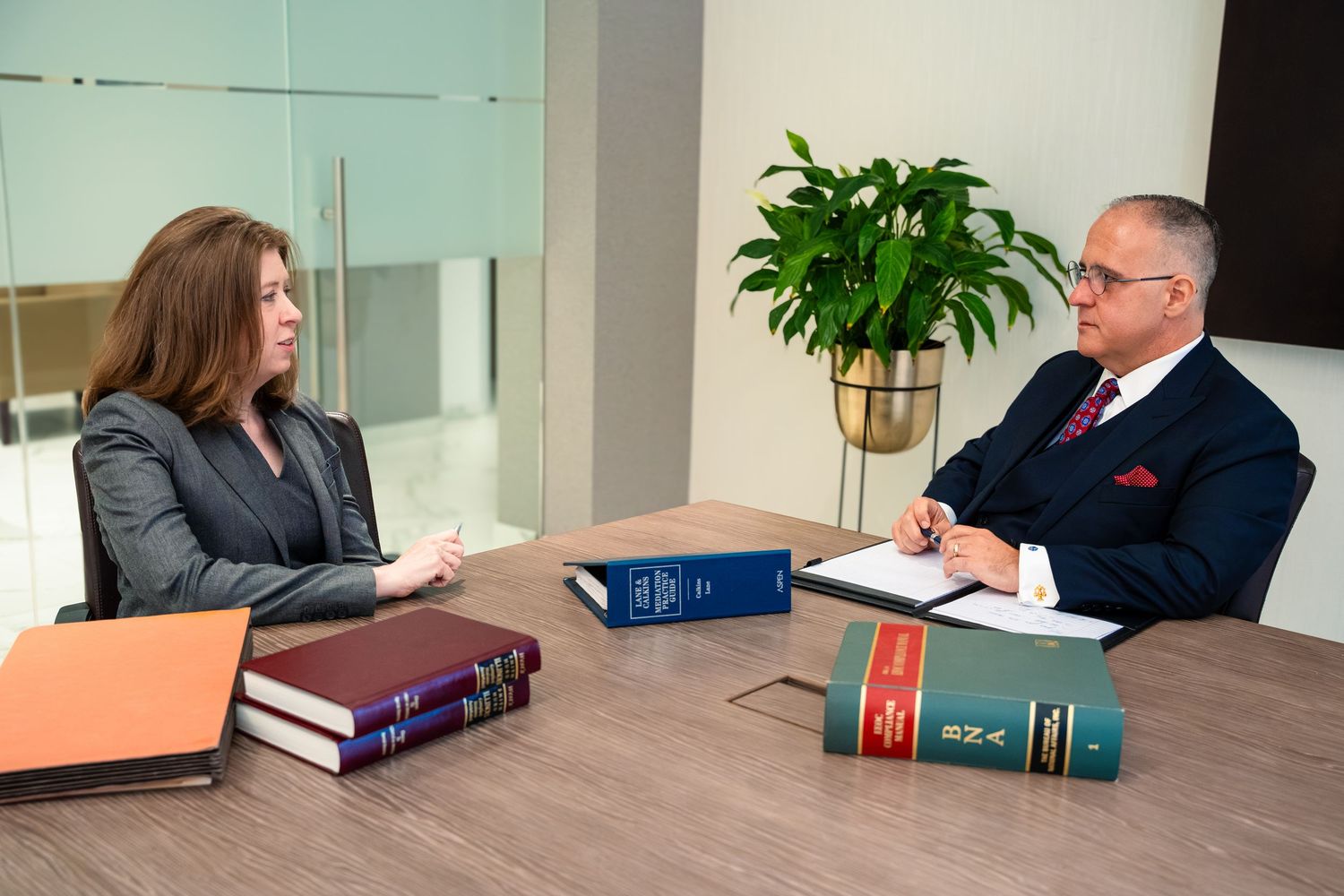 Professional consultation meeting with legal documents on conference room table.