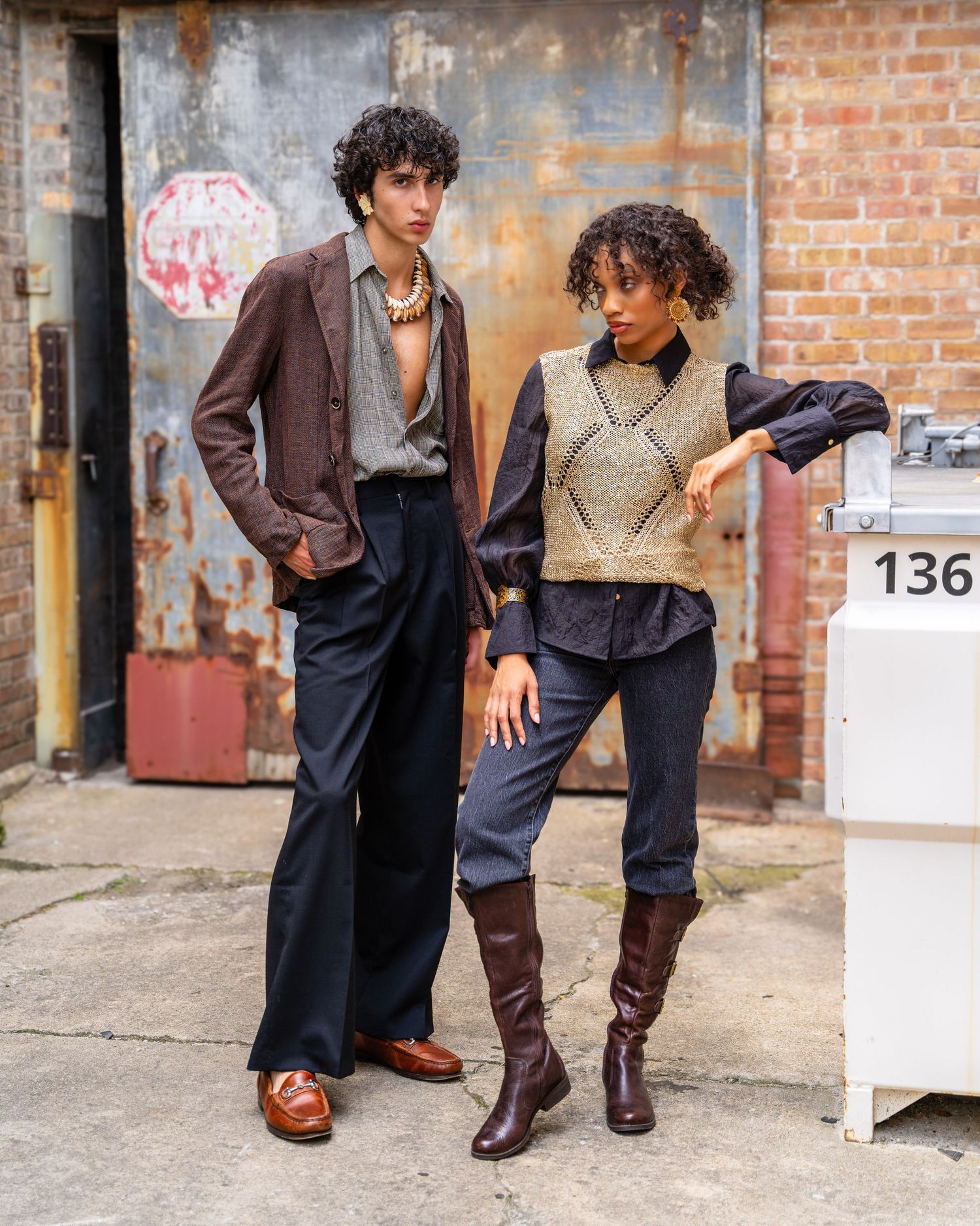 A fashion editorial photo series showing different poses of two models in dark outfits against a brick wall background.