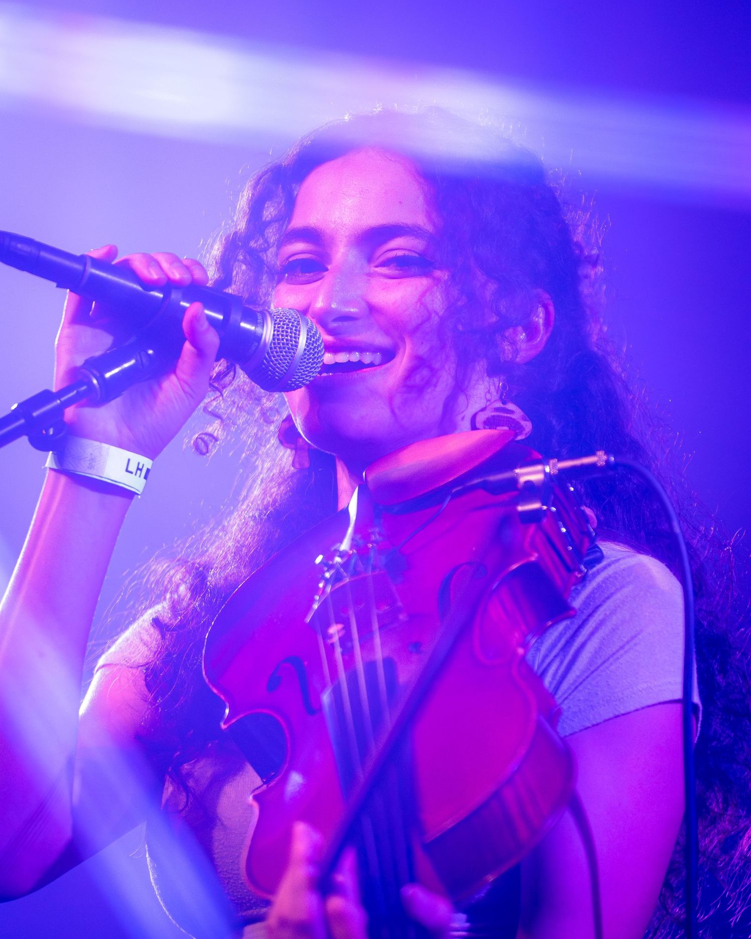 Dynamic concert shots with blue and purple lighting effects highlighting the performance.