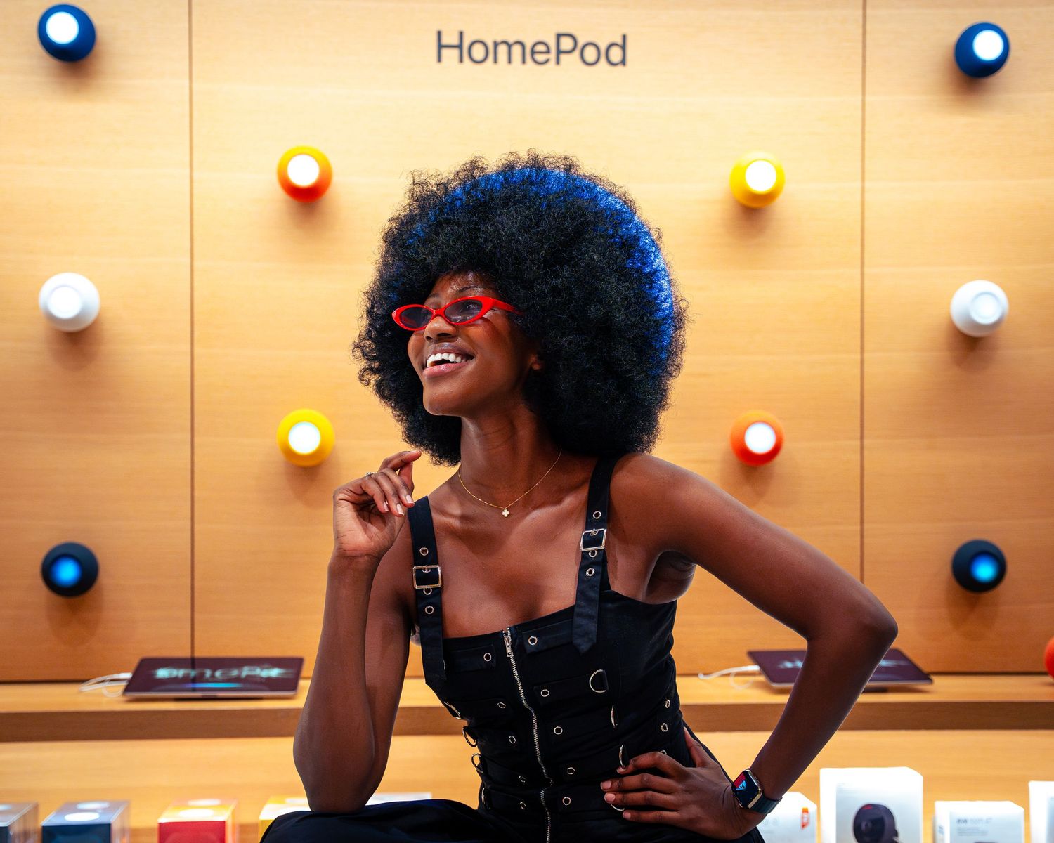 Energetic performance in front of HomePod display with warm ambient lighting.